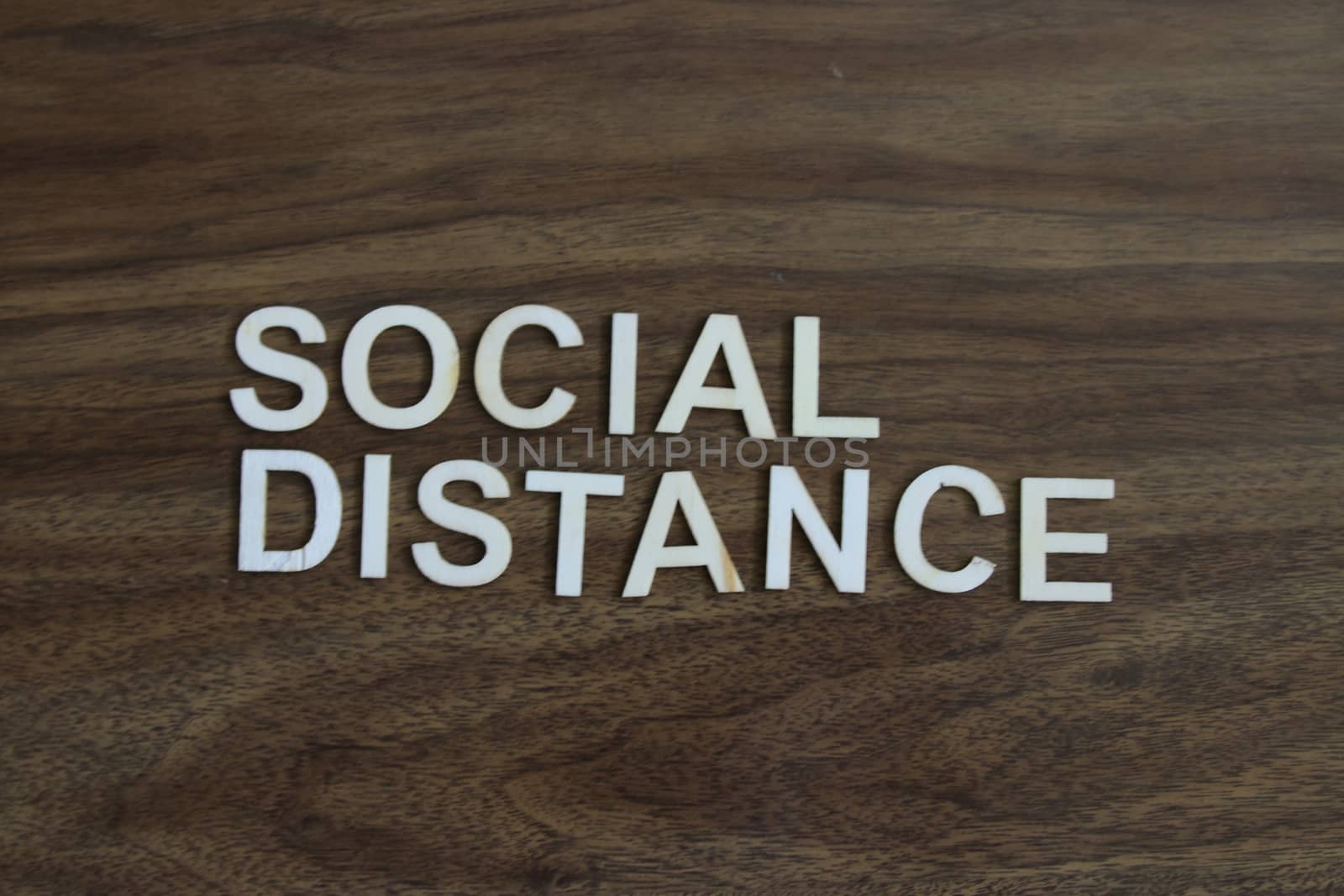 the term social distance on a wood background. High quality photo