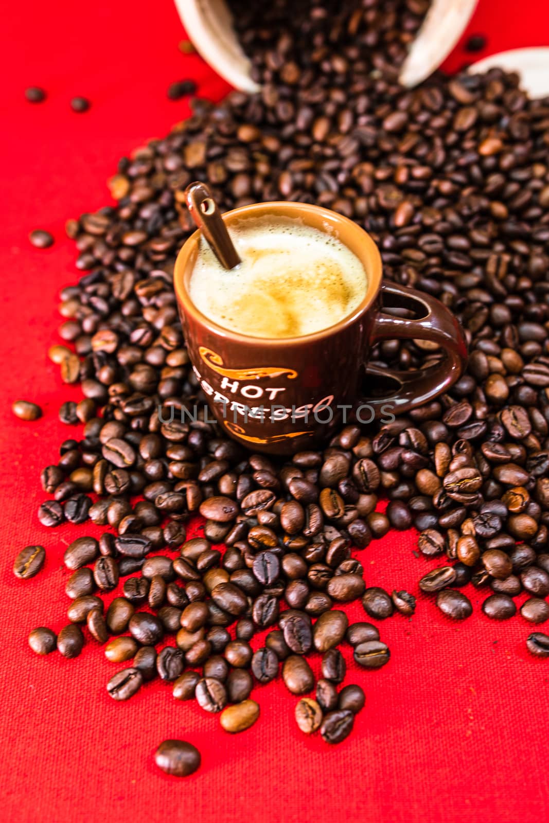 Cup of coffee, roasted coffee beans on red background, top view, copy space for text, coffee concept, close up coffee photo