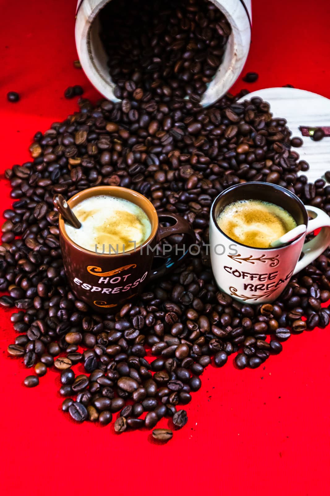 Cup of coffee, roasted coffee beans on red background, top view, copy space for text, coffee concept, close up coffee photo