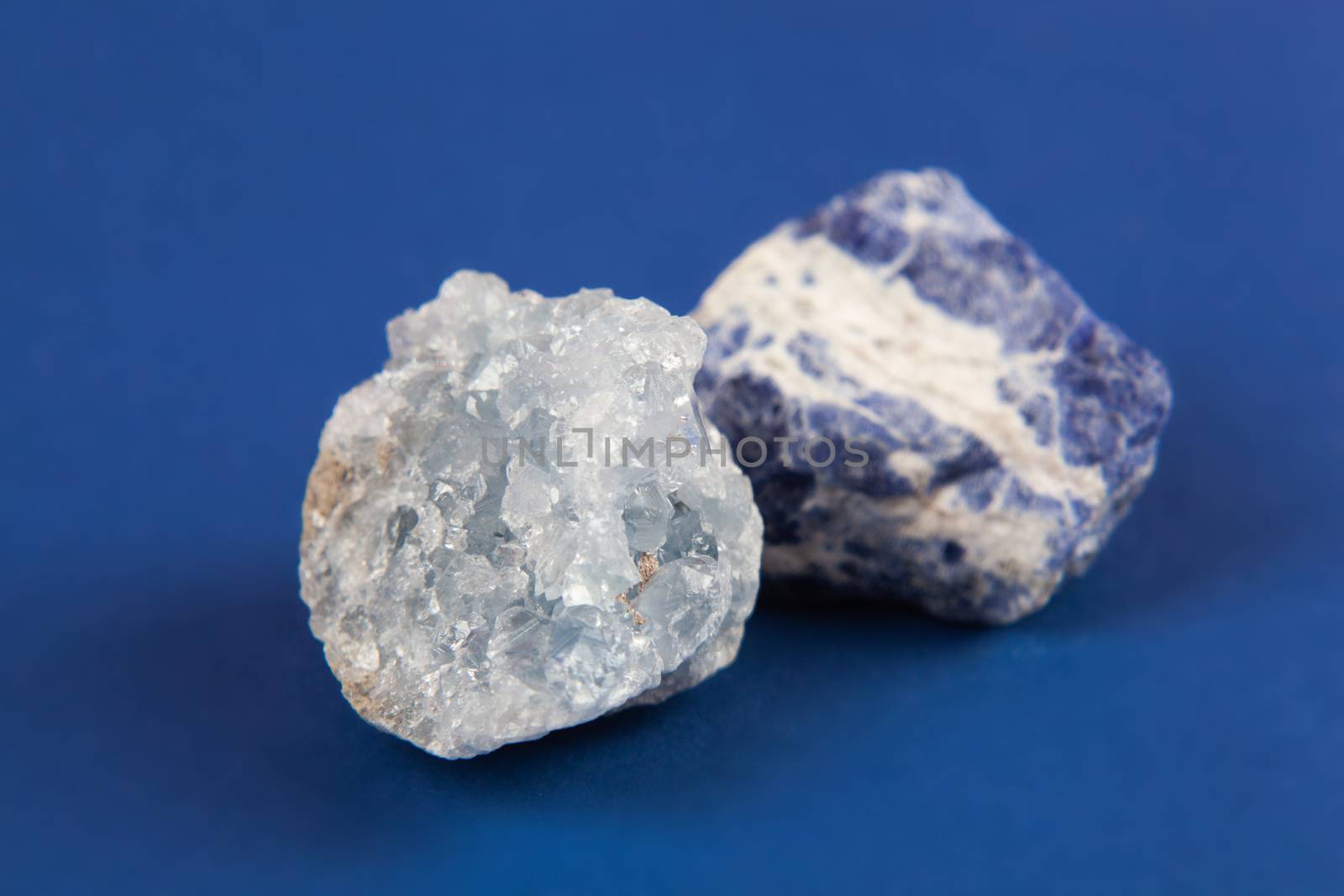 set of close up Natural minerals, precious stones on classic blue background. Use for jewelry. Space for text.