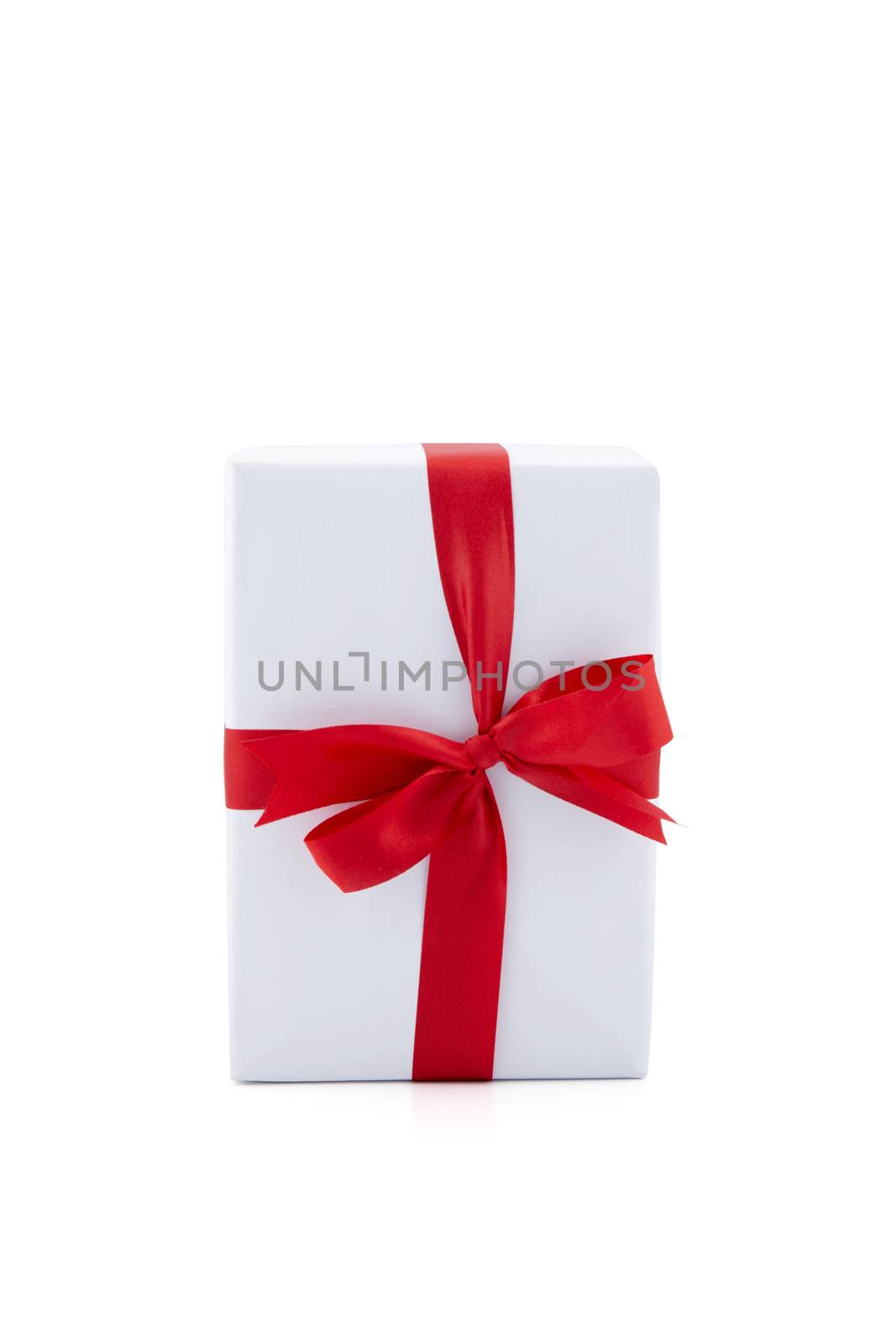 White gift box and red ribbon in season Christmas and new year i by nnudoo