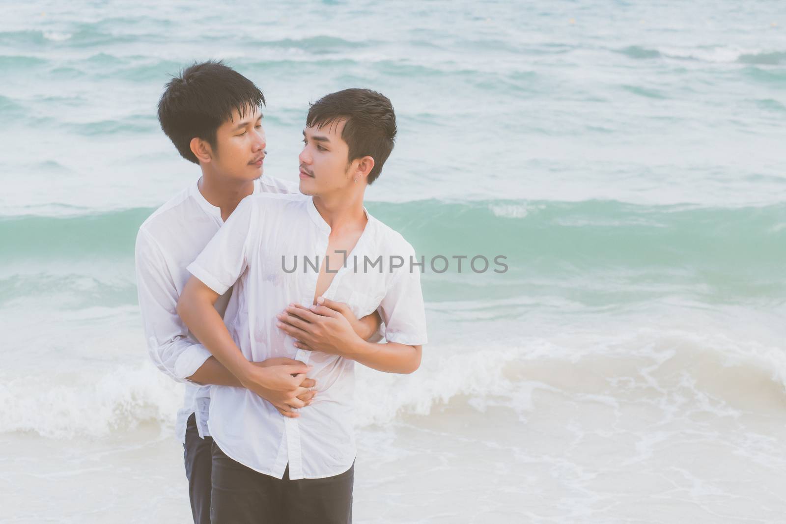 Homosexual portrait young asian couple standing hug and look tog by nnudoo