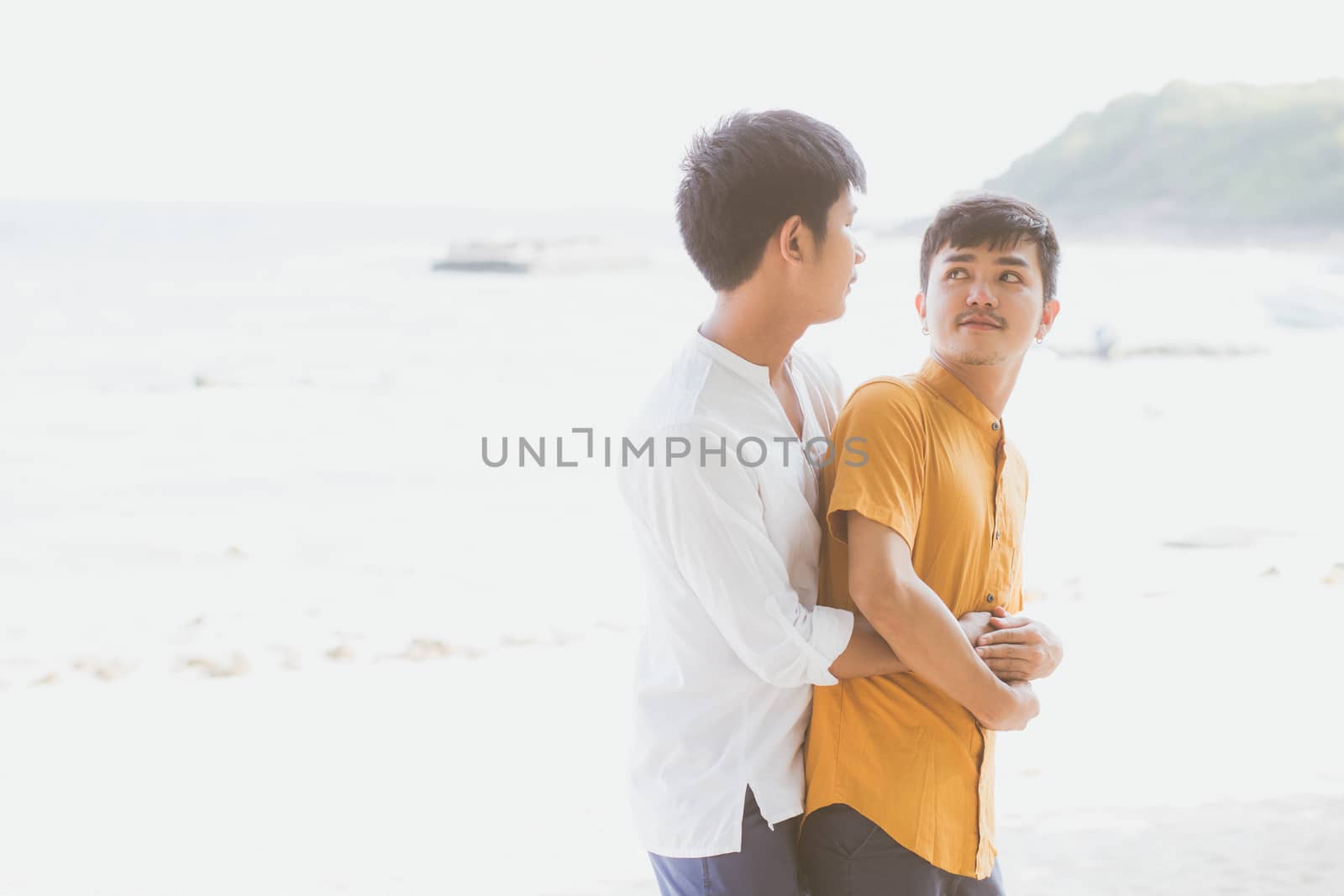 Homosexual portrait young asian couple standing hug together on  by nnudoo