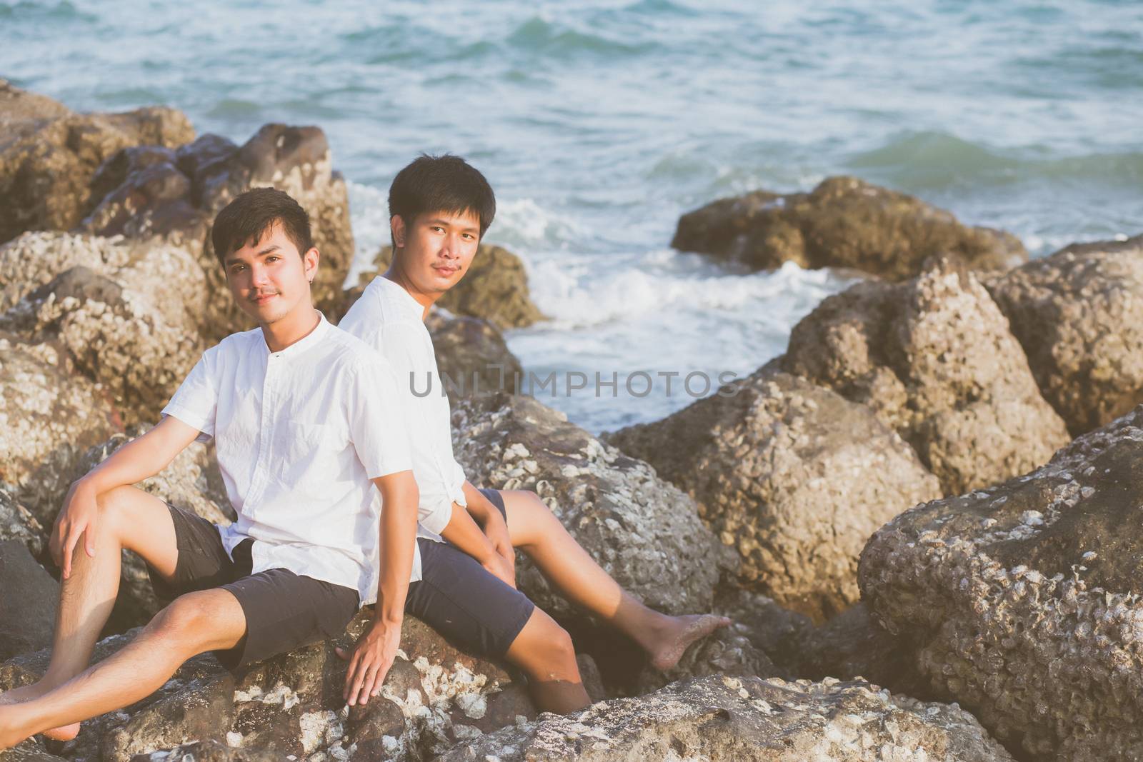 Homosexual portrait young asian couple sitting hug together on r by nnudoo