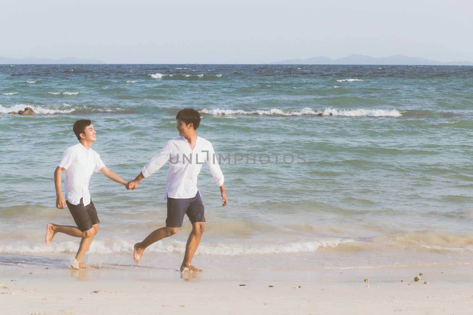 Homosexual portrait young asian couple running with cheerful tog by nnudoo