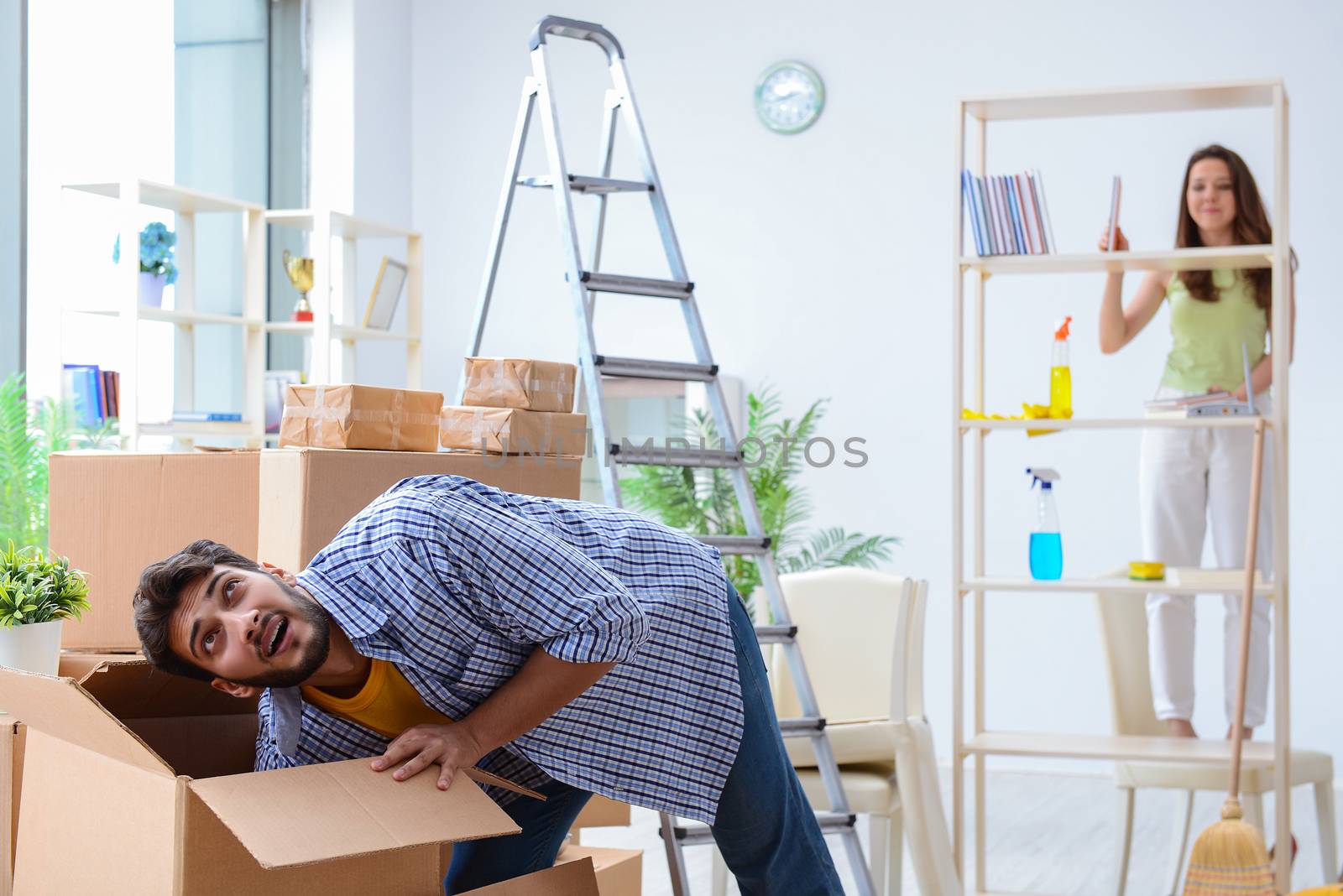 Young family unpacking at new house with boxes