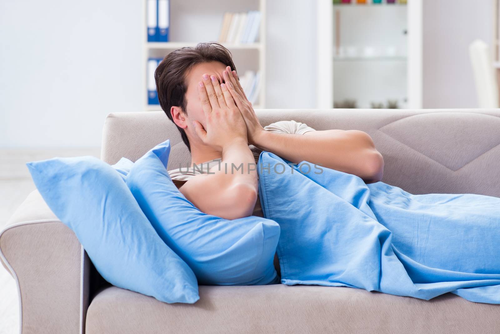 Man suffering from insonmia in bed at home