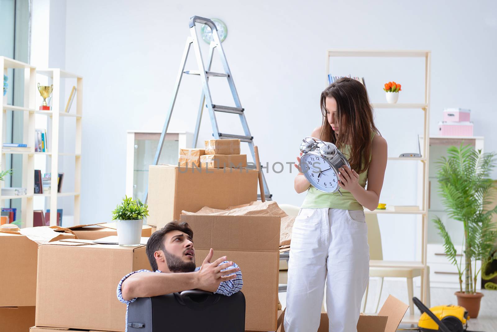 Young family unpacking at new house with boxes