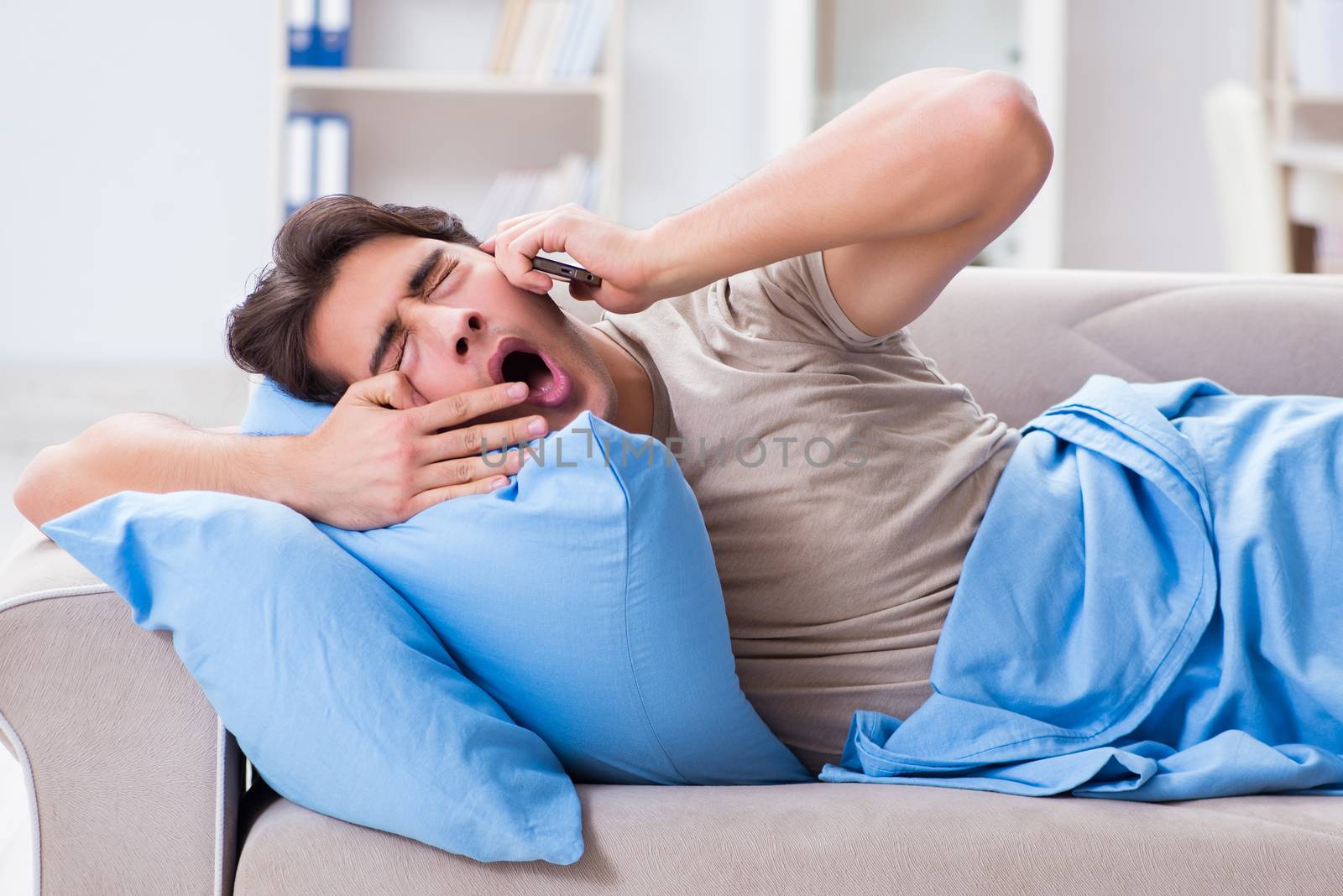 Man addicted to his mobile phone in bed
