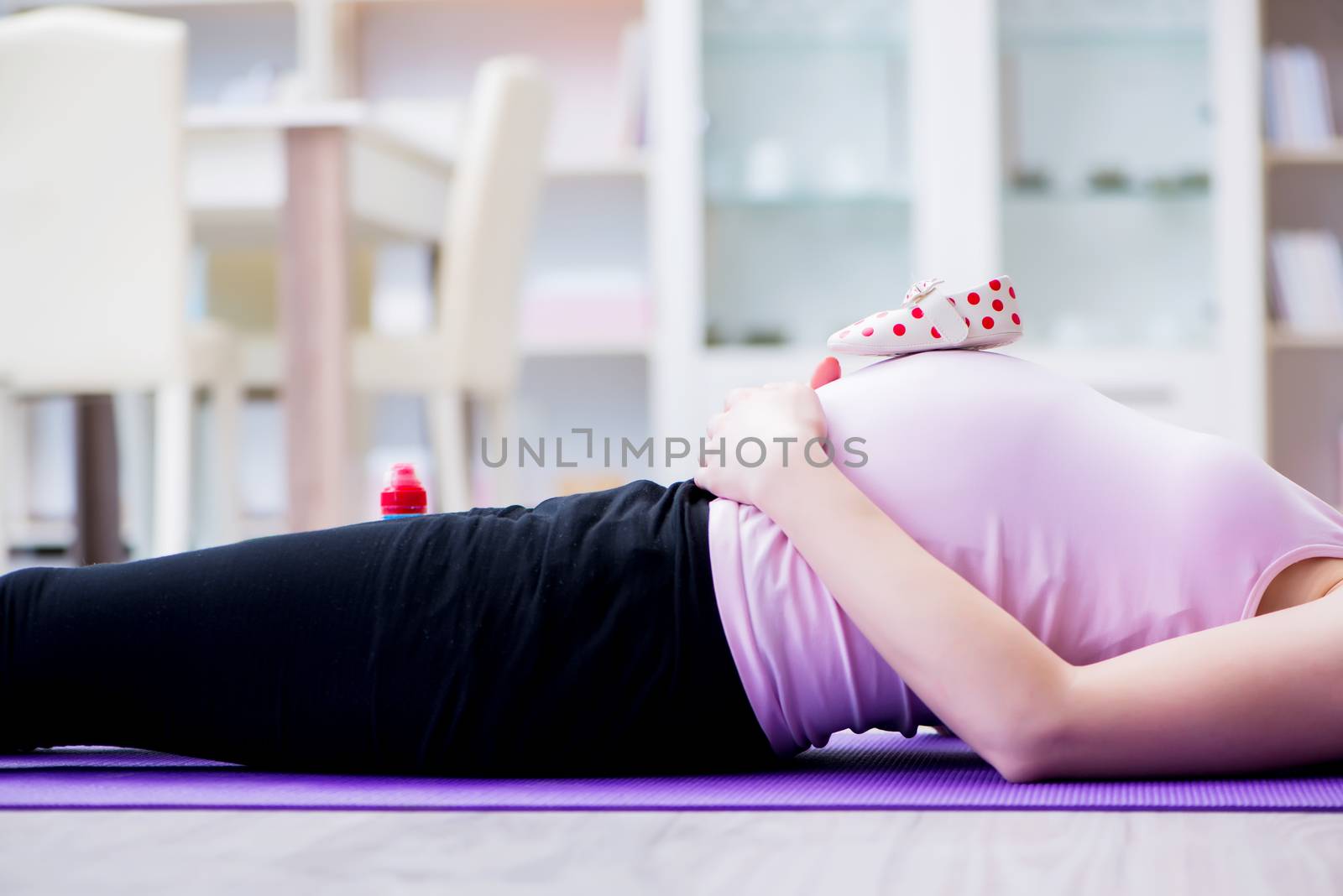 Pregnant woman exercising in anticipation of child birth