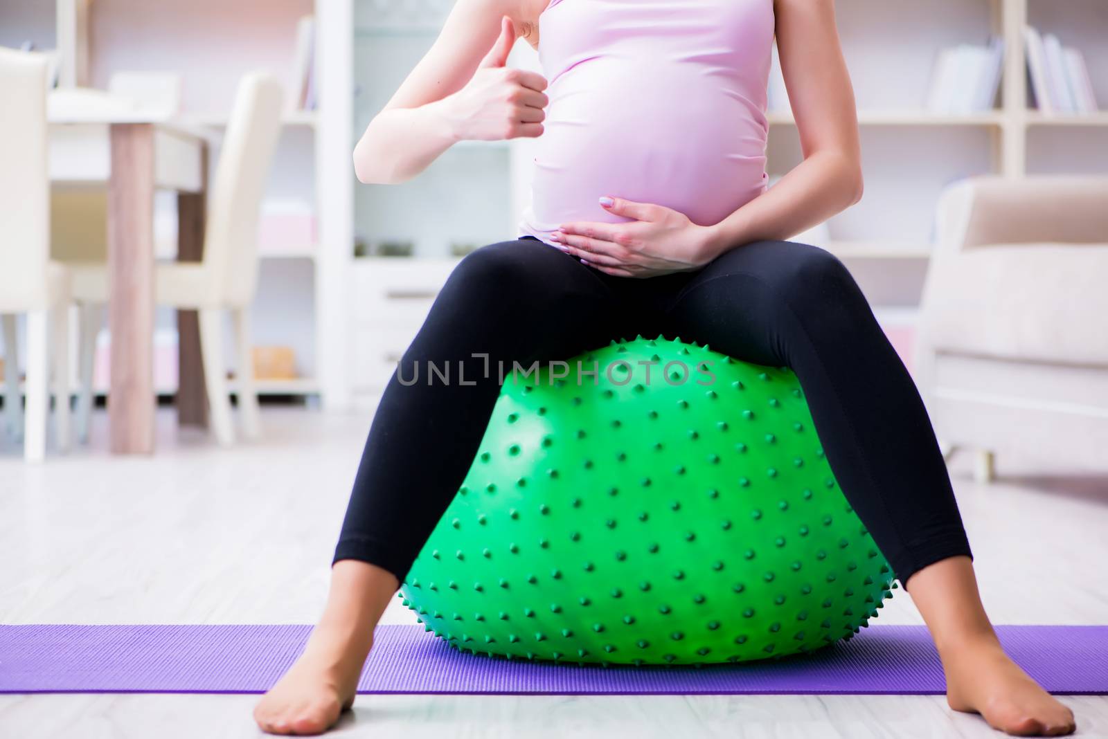 Pregnant woman exercising in anticipation of child birth