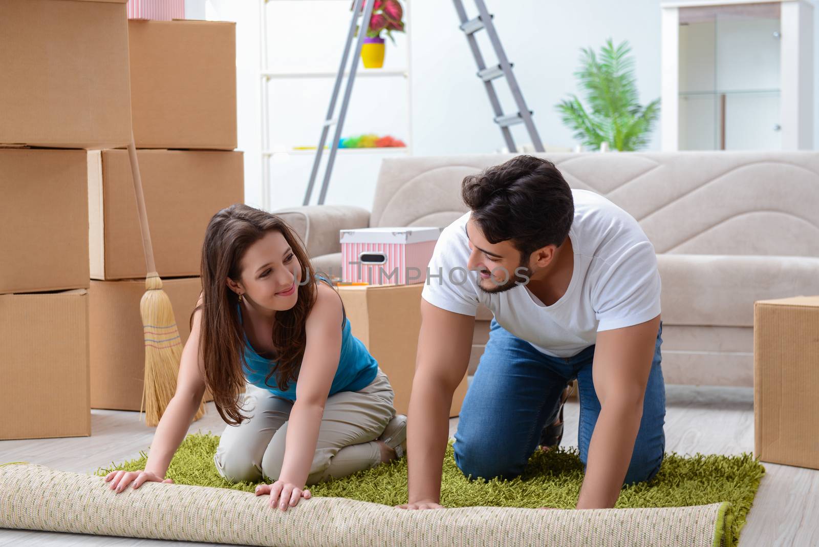 Young family unpacking at new house with boxes