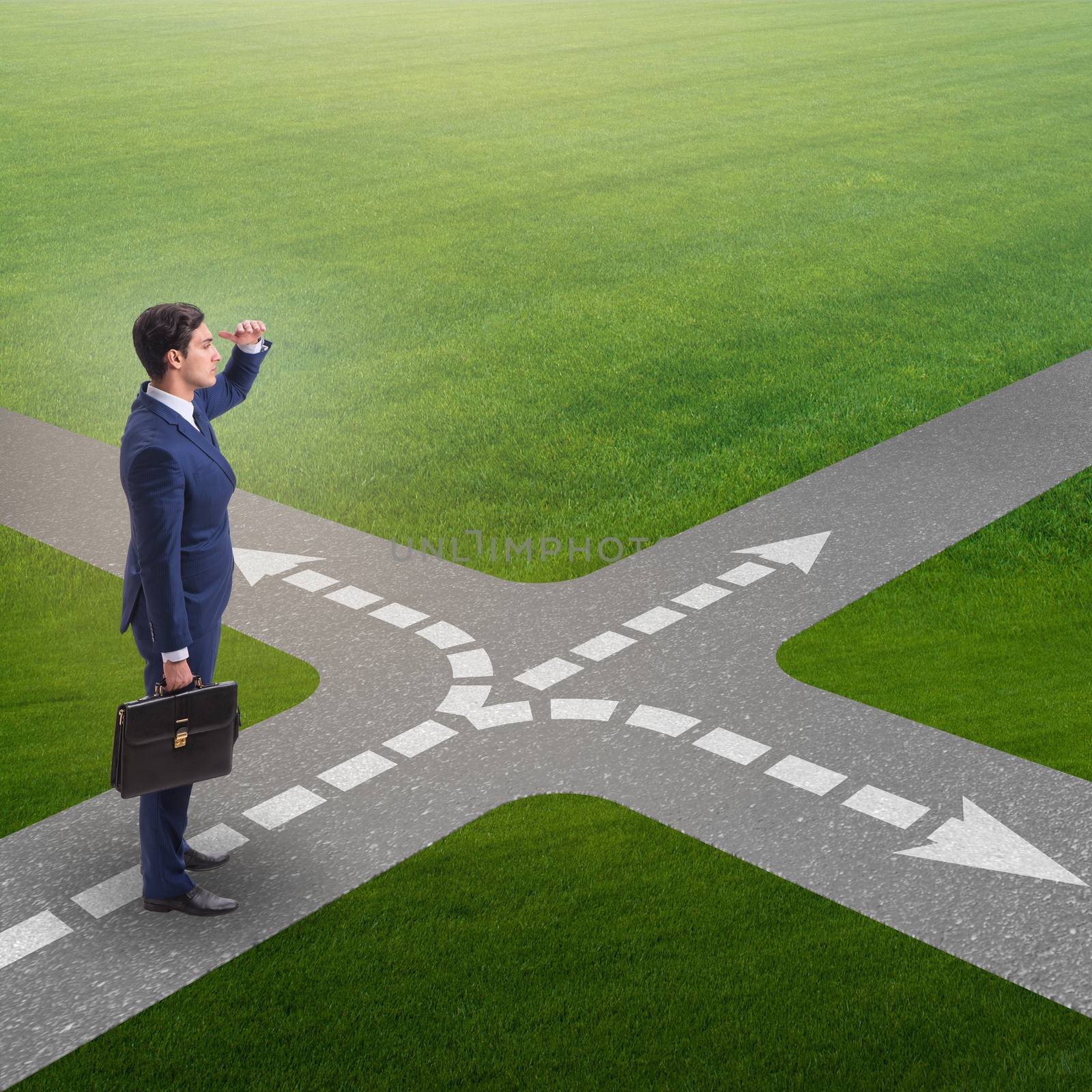 Young businessman at crossroads in uncertainty concept by Elnur