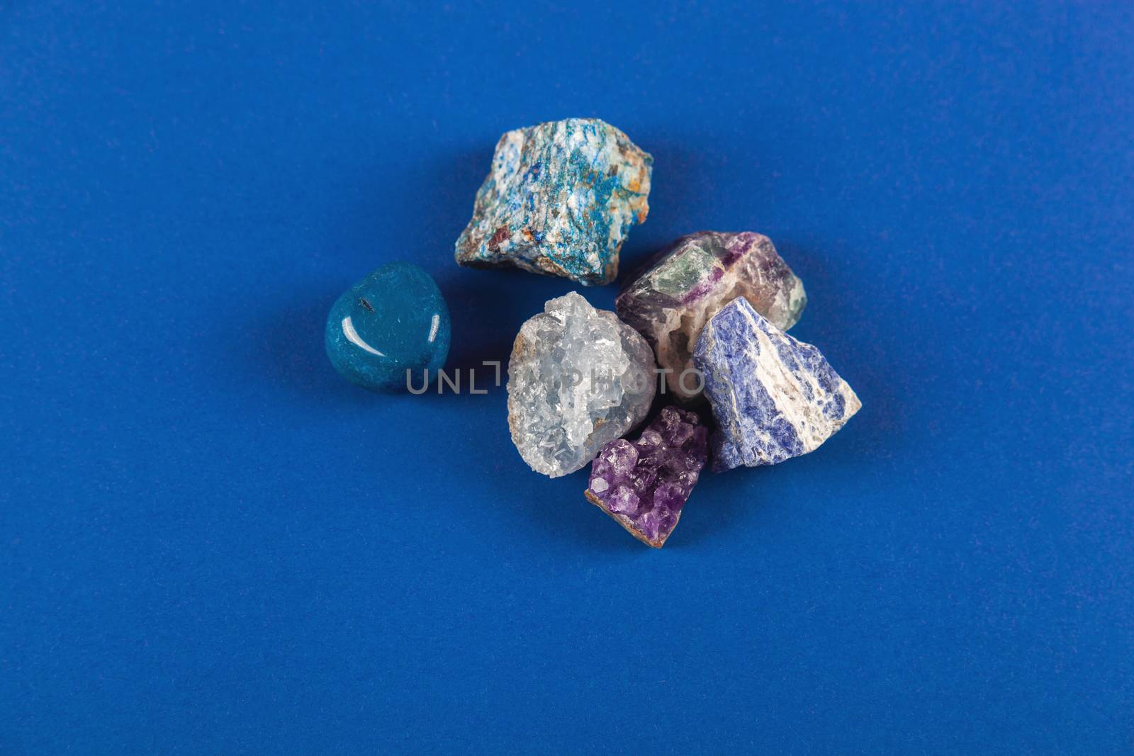 Natural minerals, precious stones on classic blue background by polyats