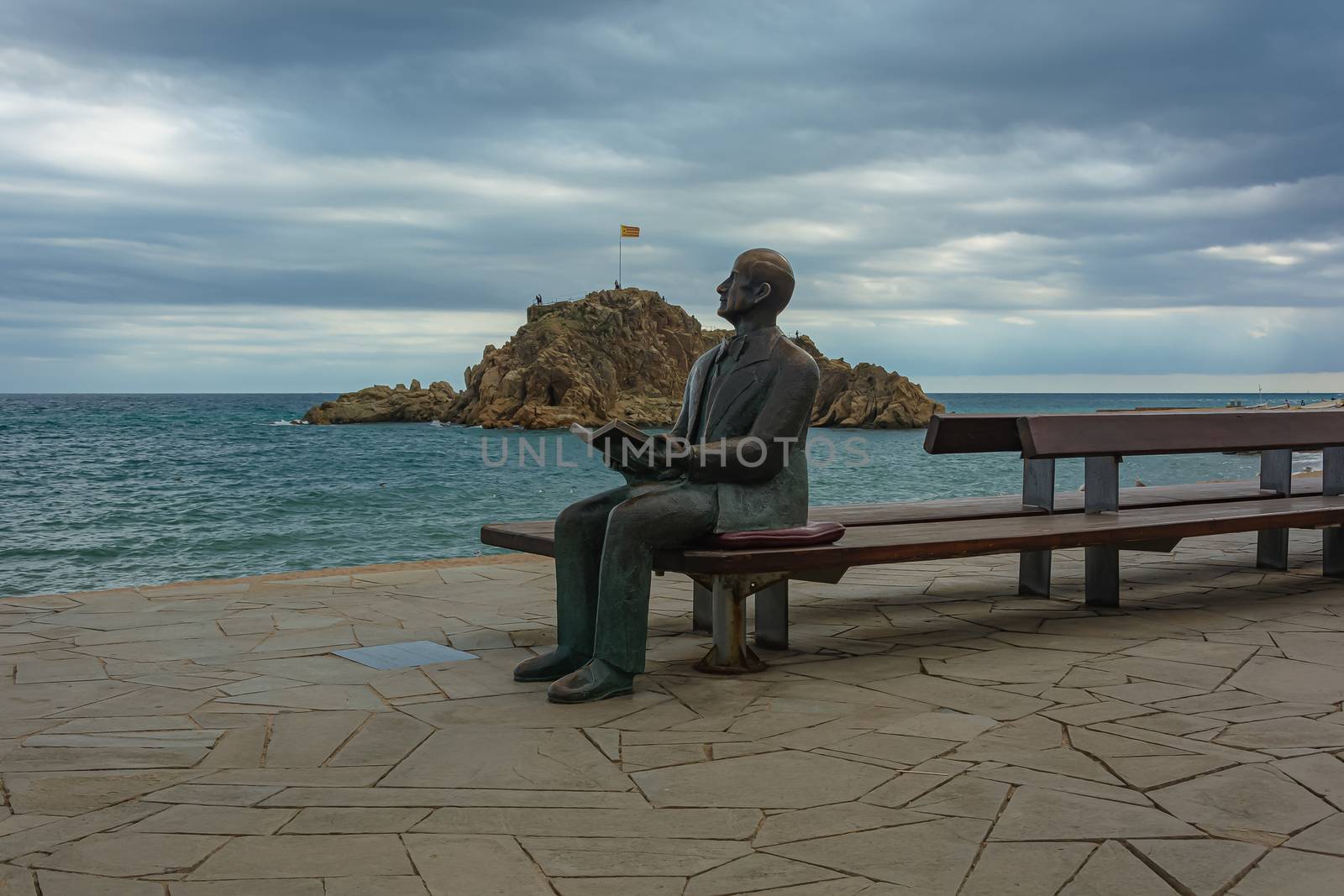 Spain, Blanes-09/14/2017: Monument to a man with a book on the background of a seascape.. Stock photo