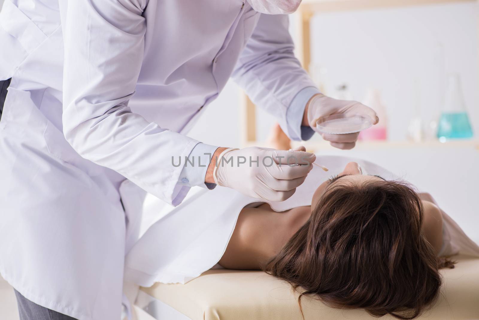 Police coroner examining dead body corpse in morgue