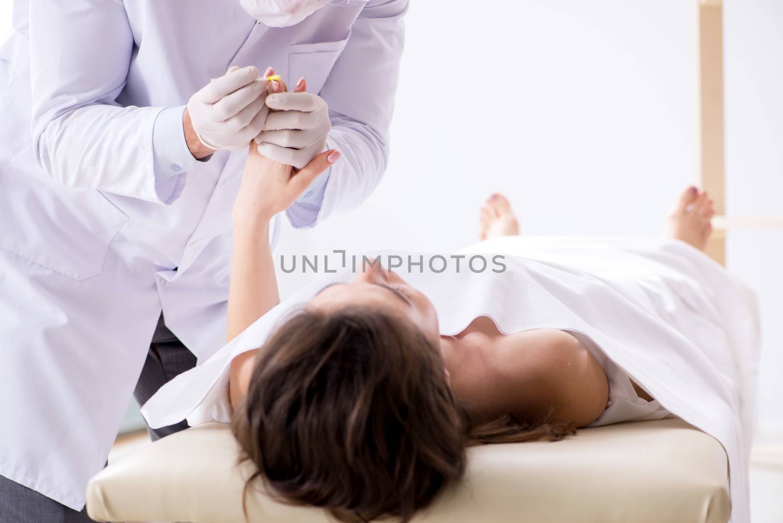 Police coroner examining dead body corpse in morgue