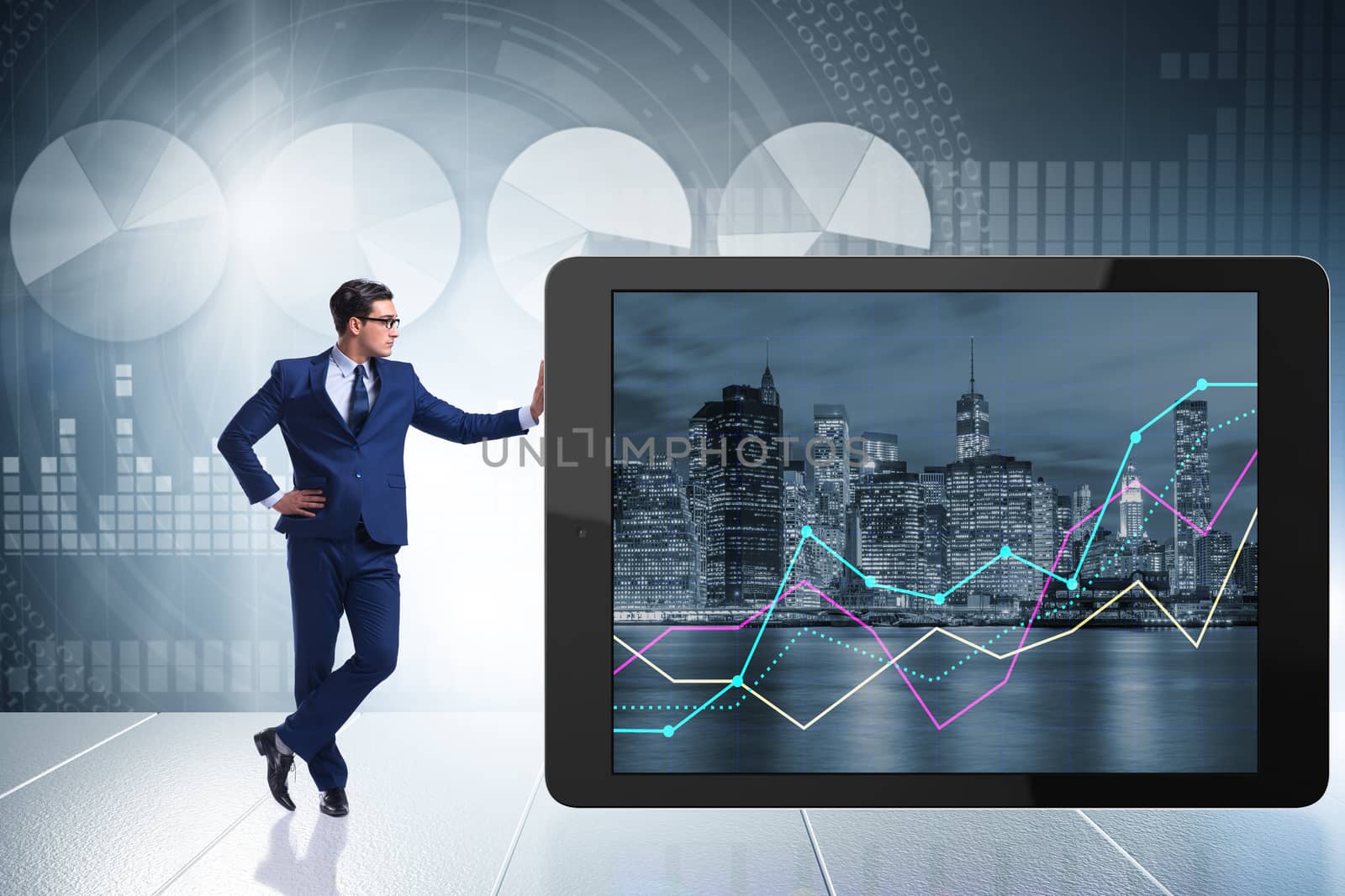 Businessman standing next to tablet computer in business concept