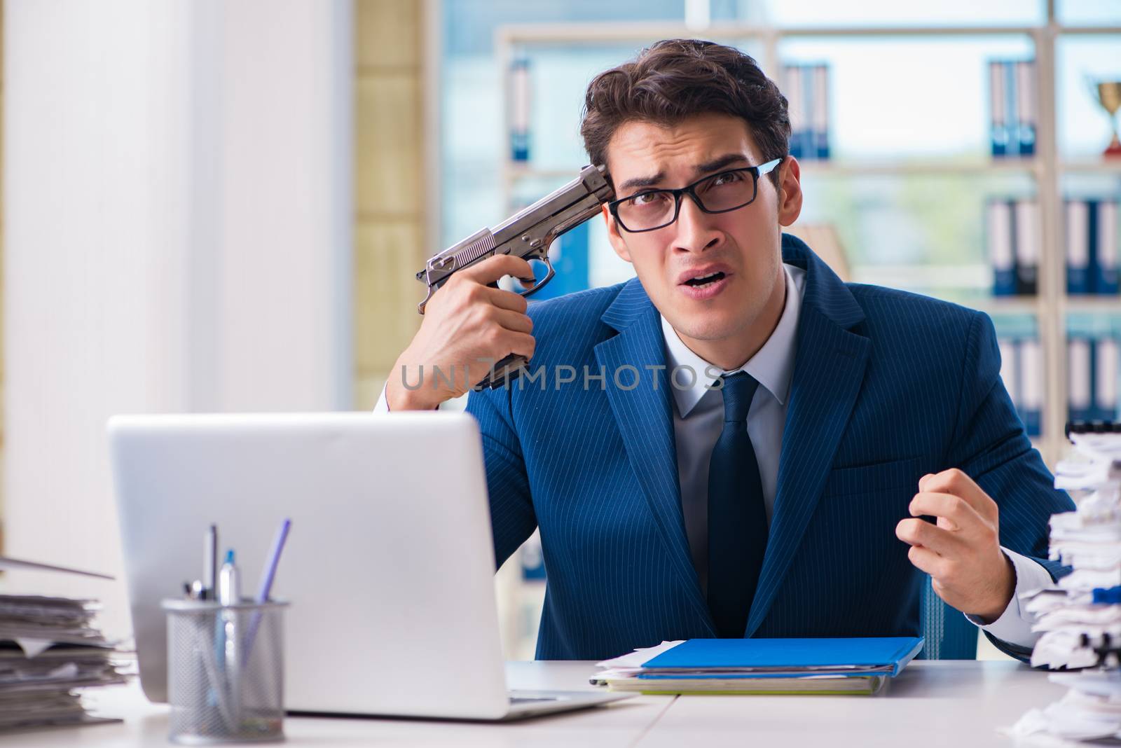 Stressed businessman thinking of suicide due to excessive workload