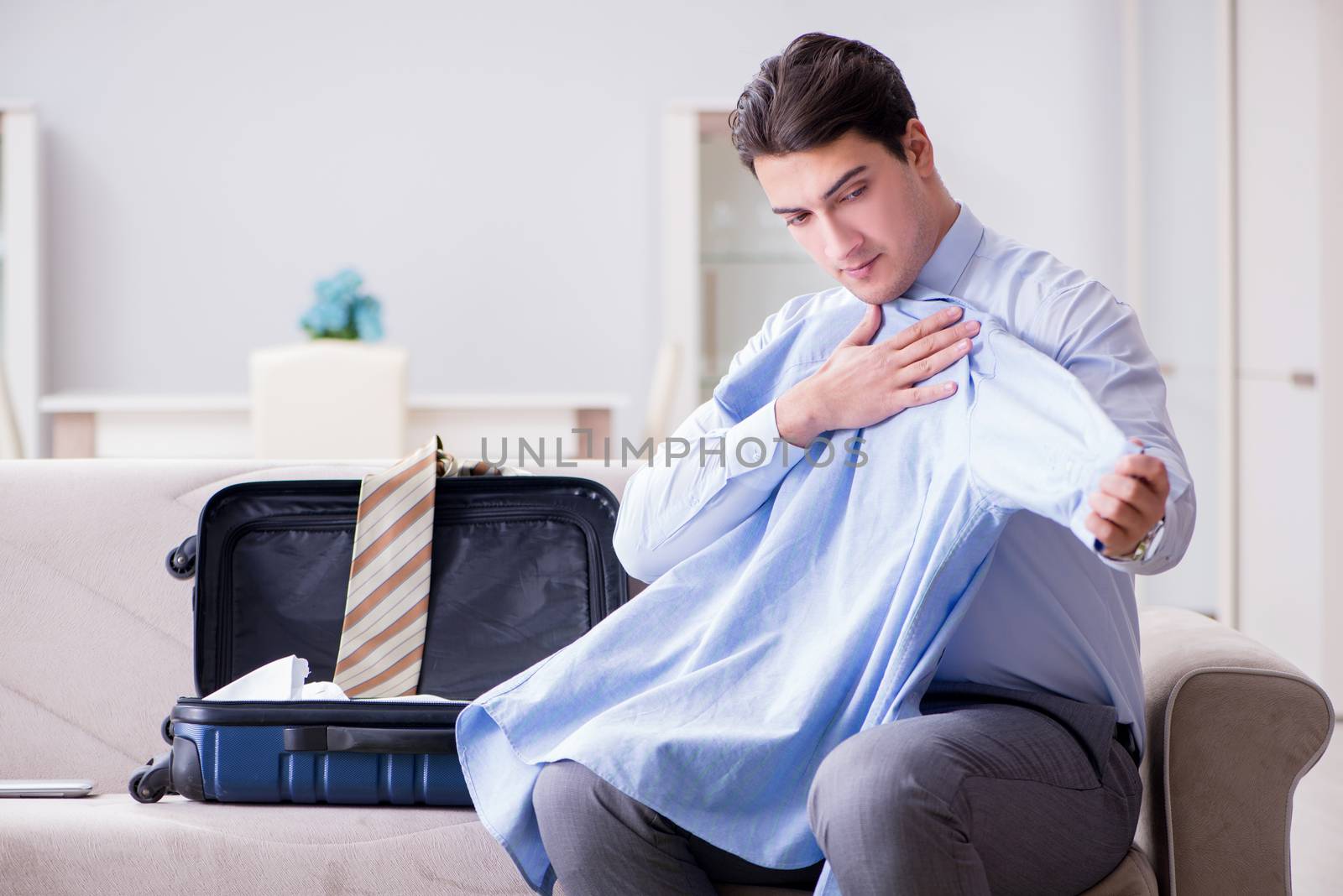 Businessman preparing packing for business trip