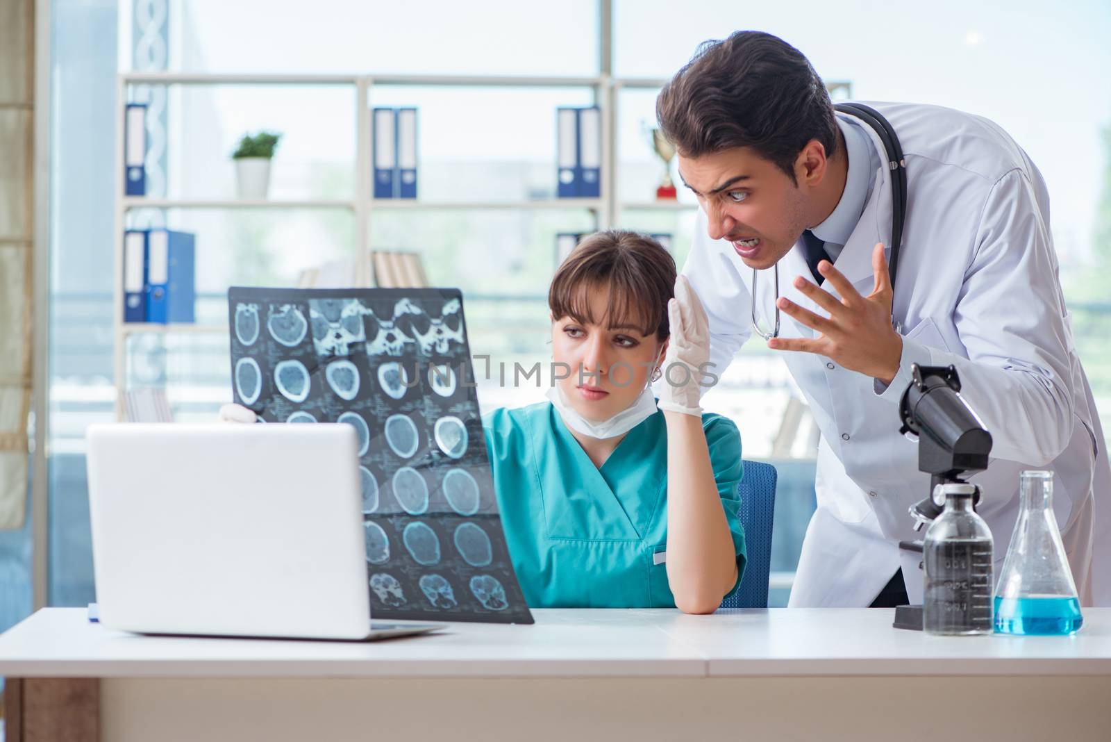 Two doctors discussing x-ray MRI image in hospital