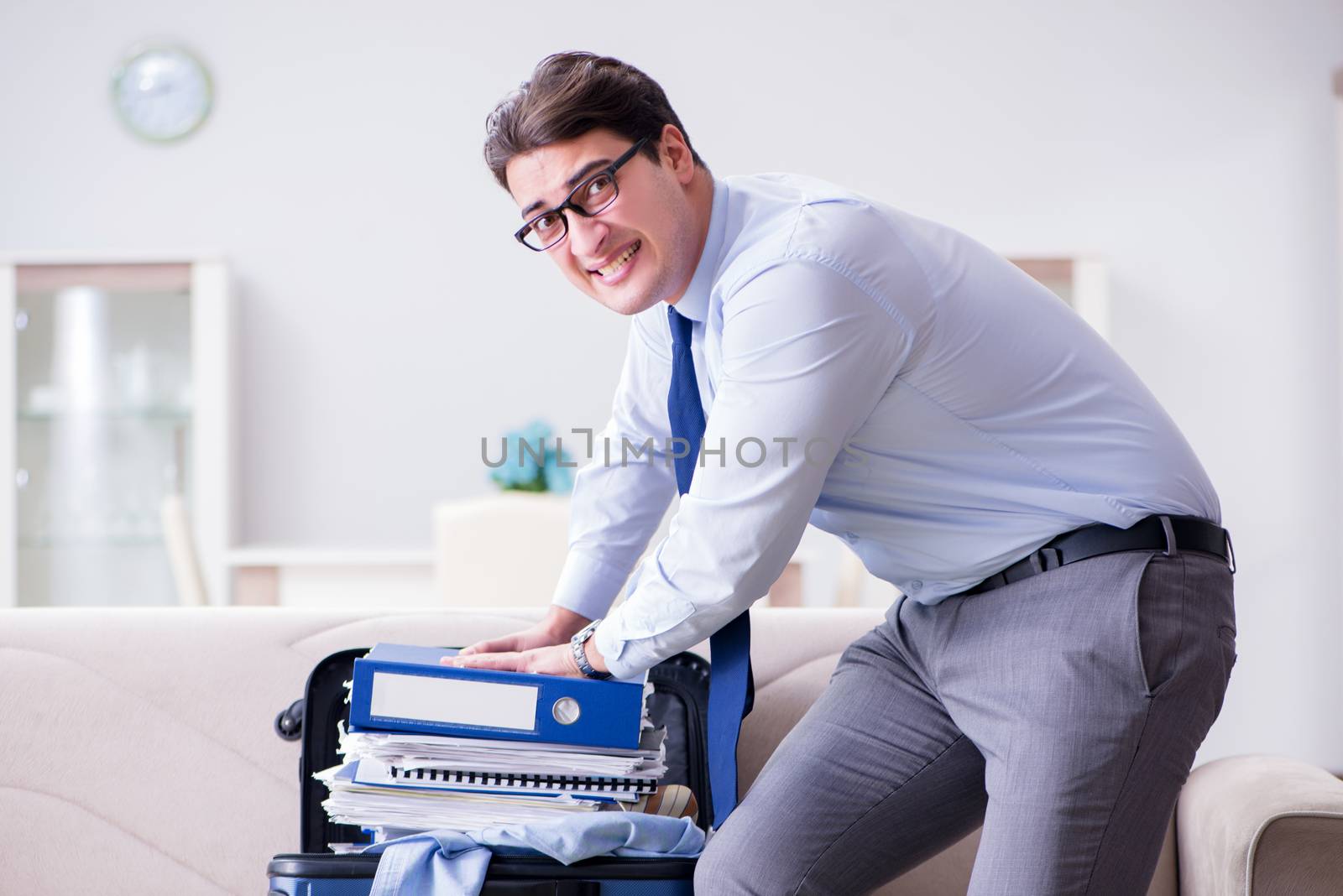 Businessman preparing packing for business trip