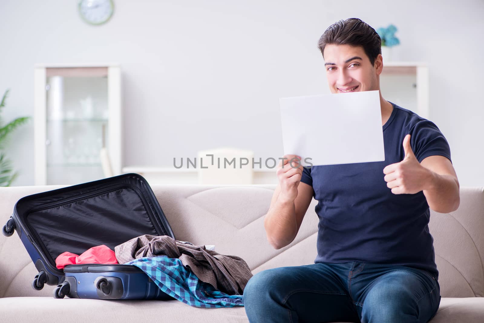 Young man preparing packing for summer vacation