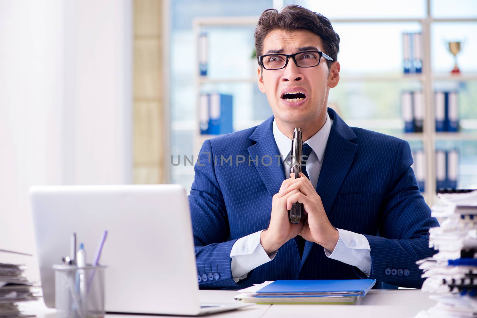 Stressed businessman thinking of suicide due to excessive workload