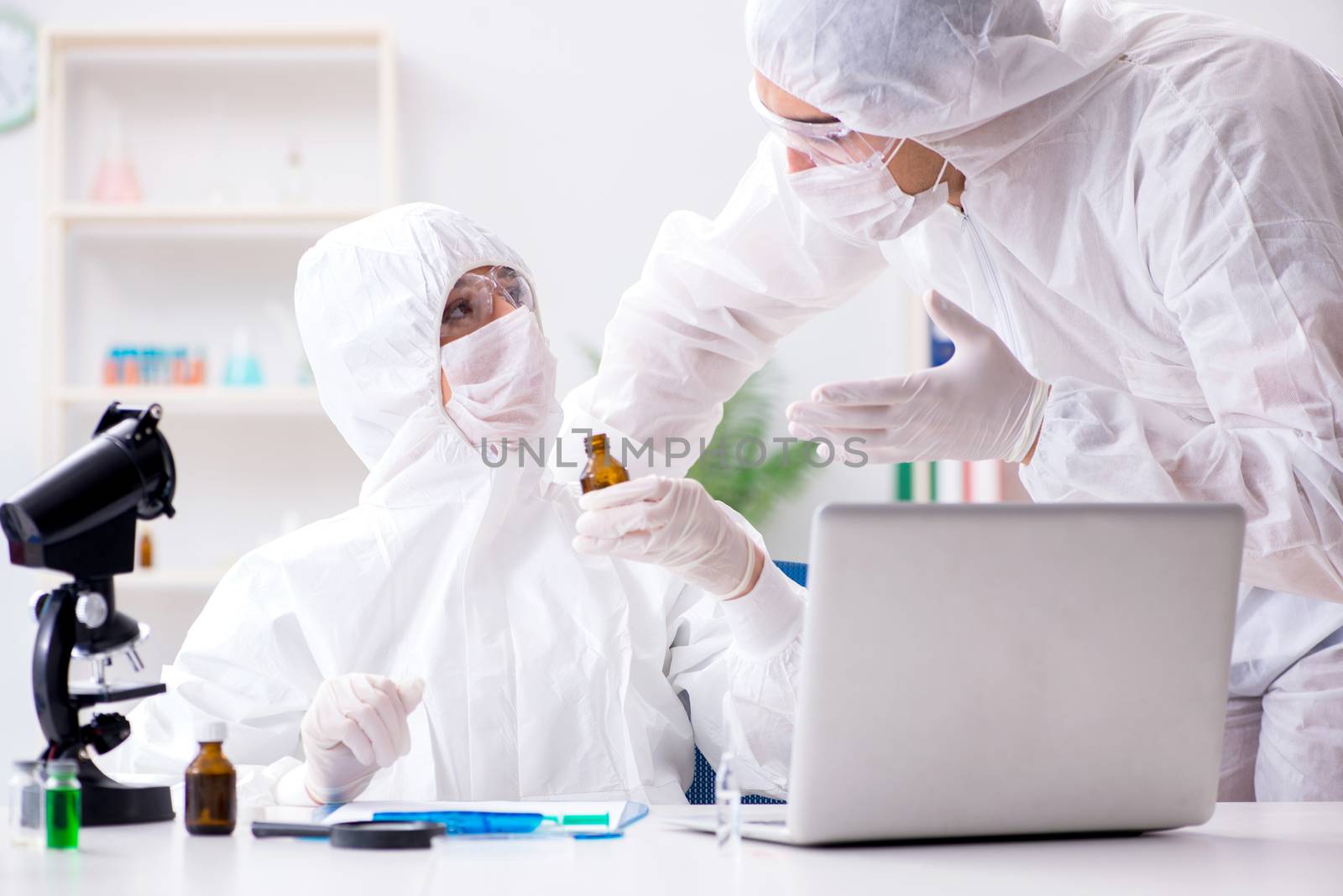Two chemists working in the lab