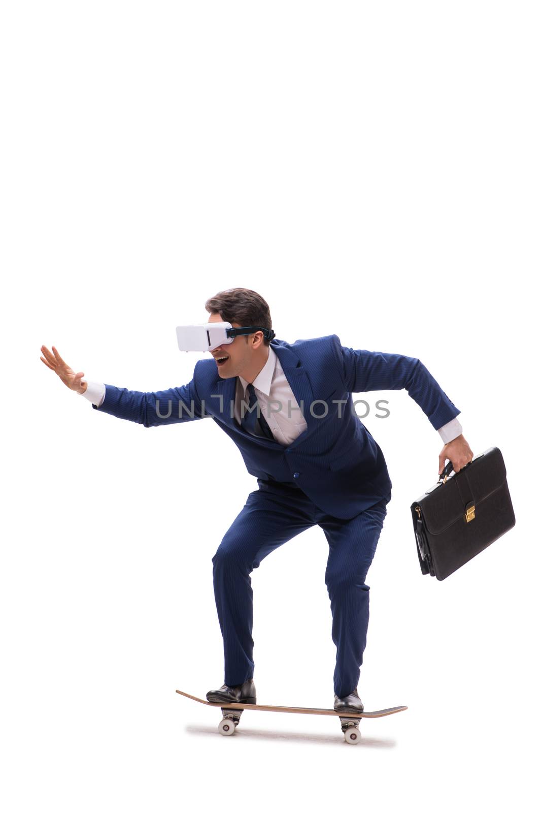 Businessman wearing virtual reality glasses riding skateboard on white