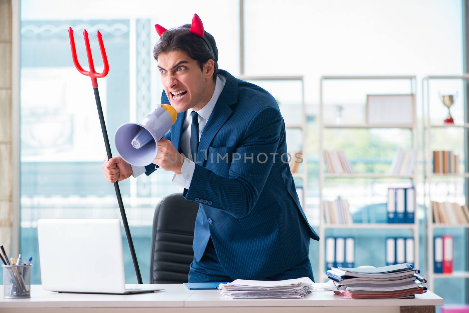 Devil angry businessman in the office