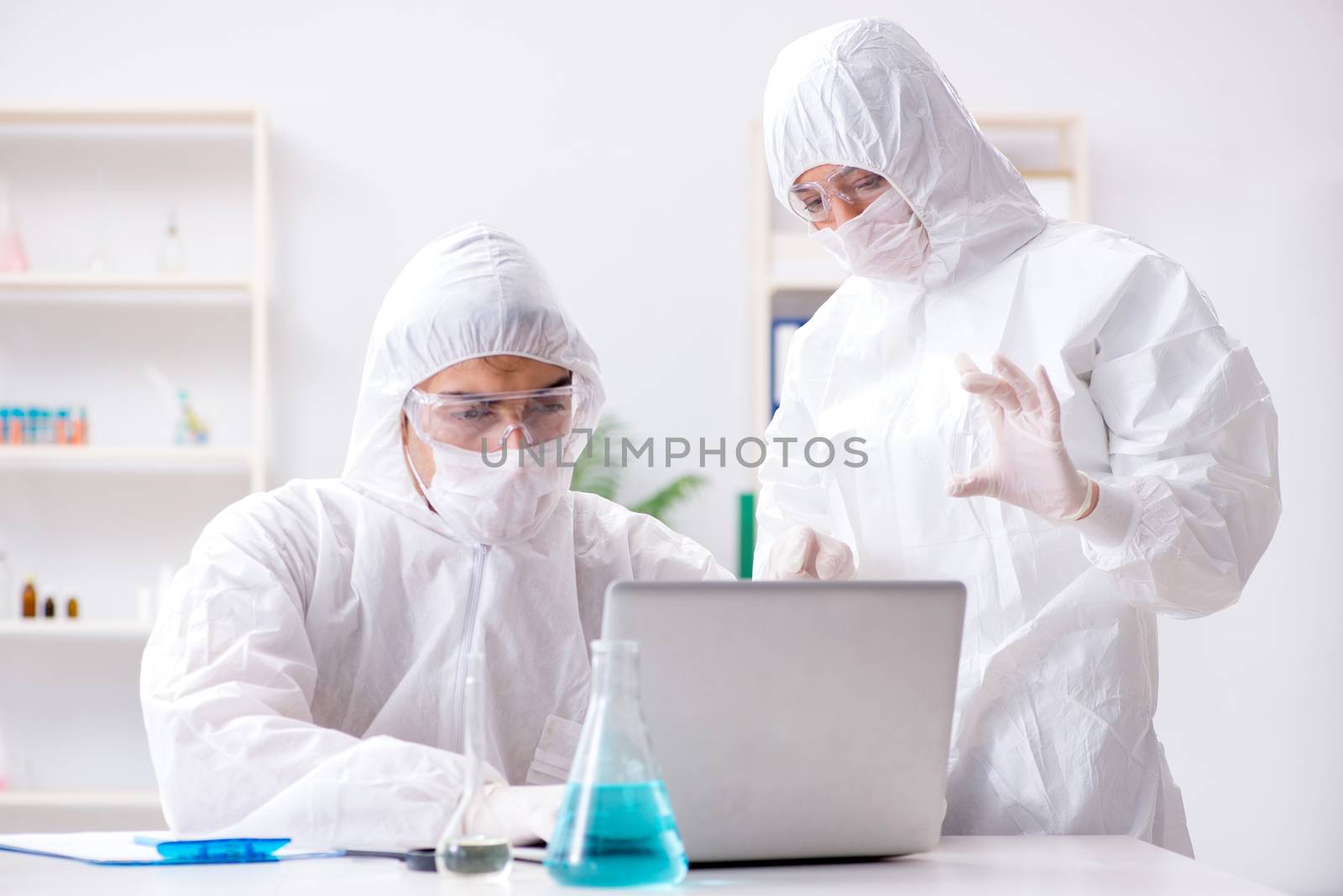 Two chemists working in the lab