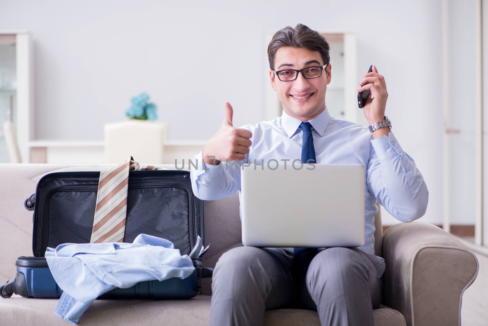 Businessman preparing packing for business trip