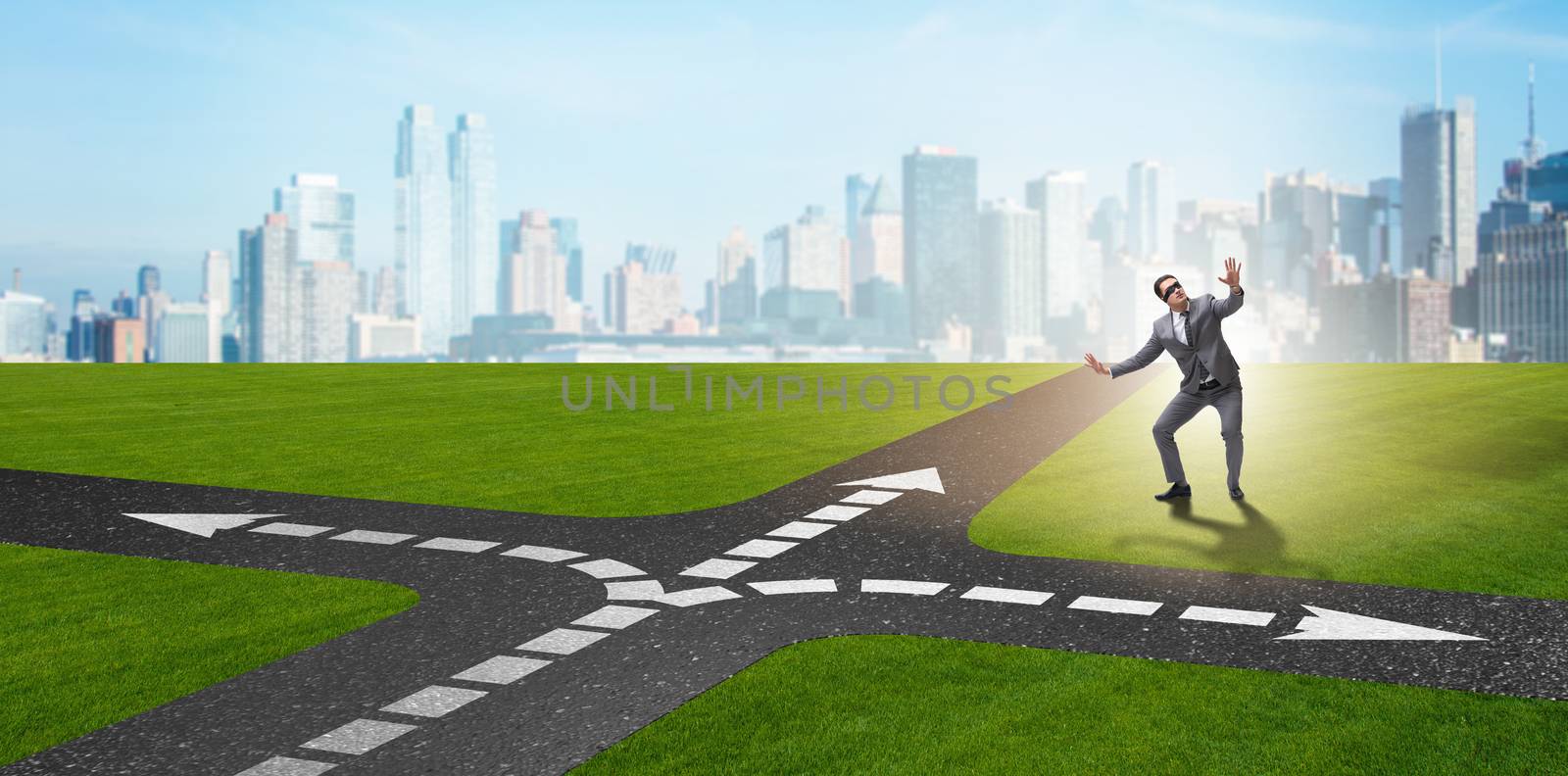 Young businessman at crossroads in uncertainty concept by Elnur