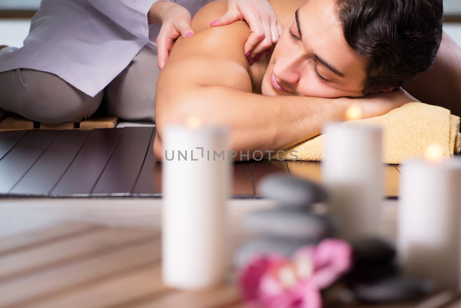 Young handsome man during spa procedure