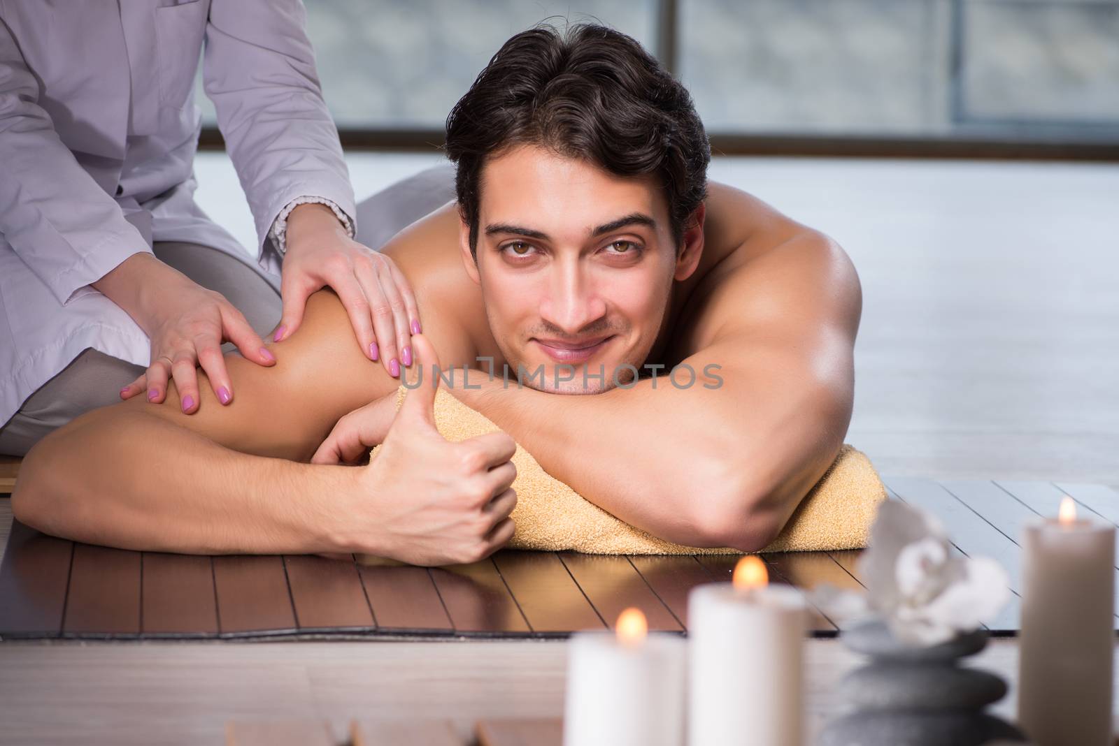 Young handsome man during spa procedure