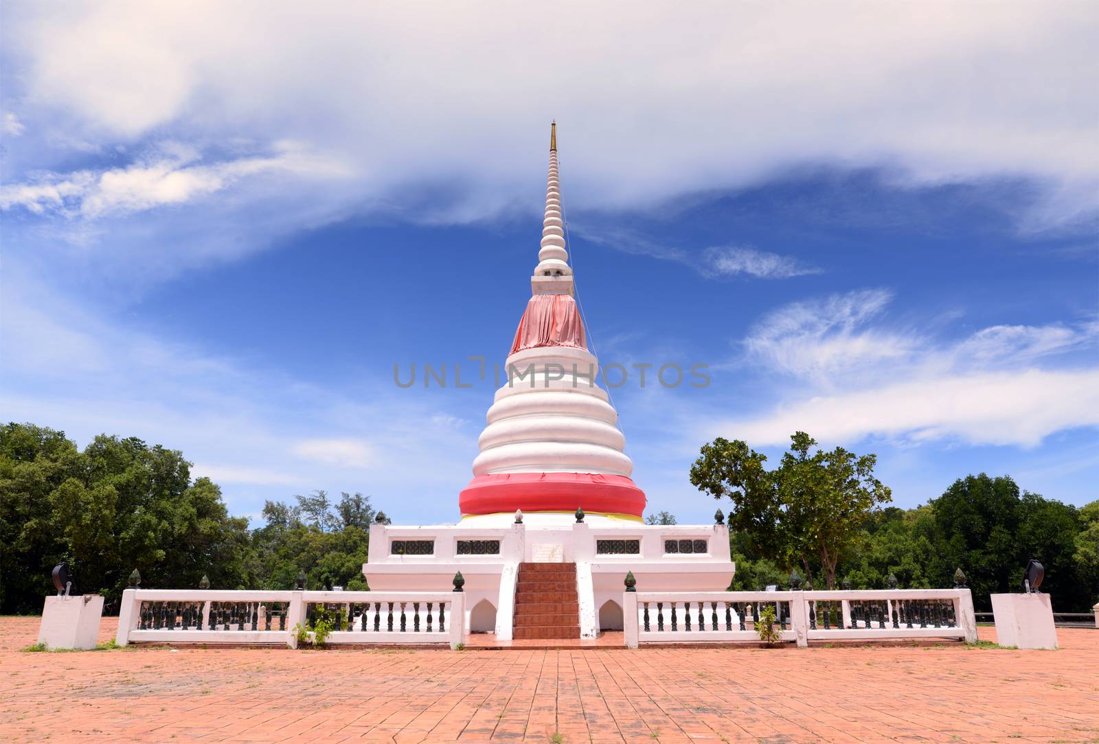 White Buddhist stupa on a bright blue sky background. by hellogiant