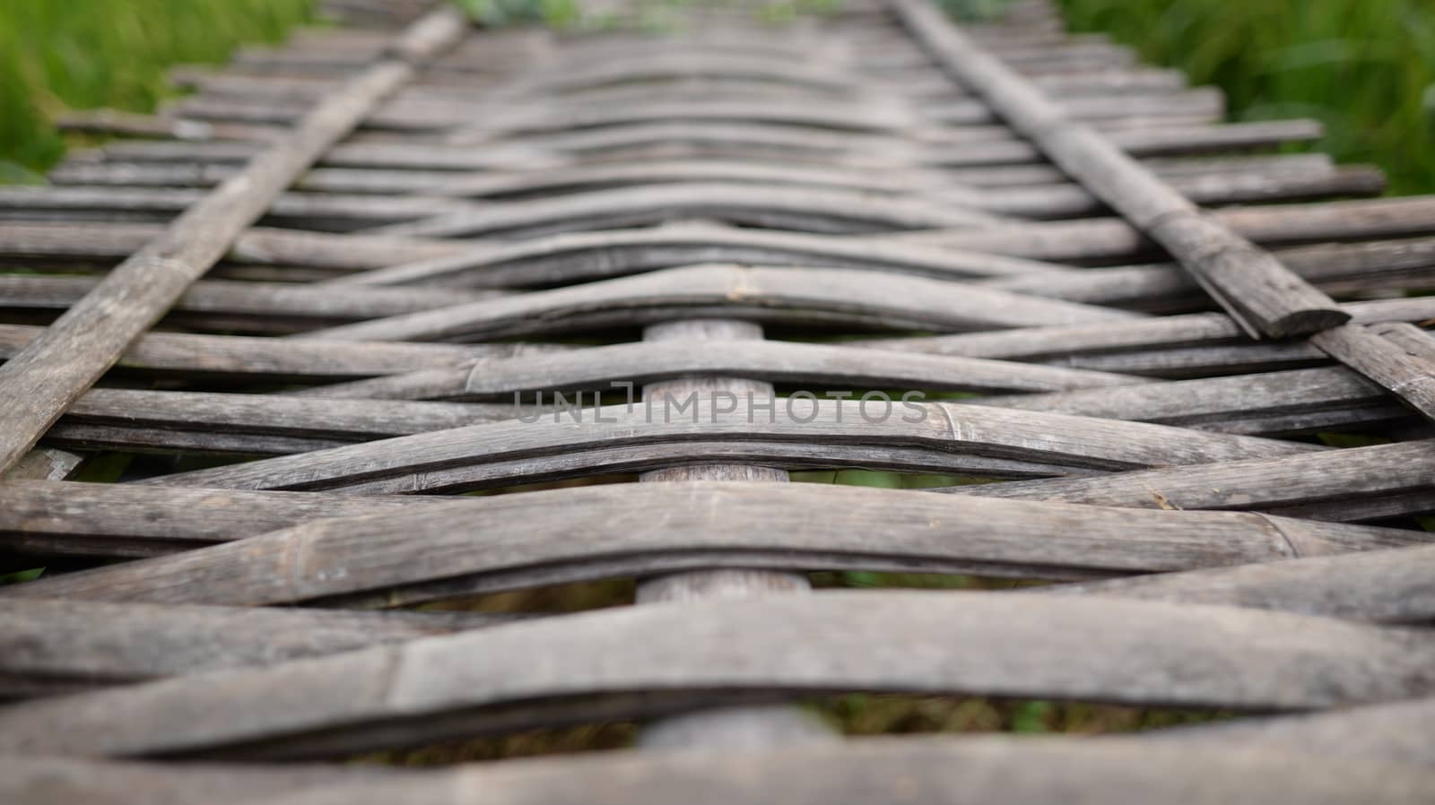 Background image of a bridge made of bamboo weaving together by hellogiant