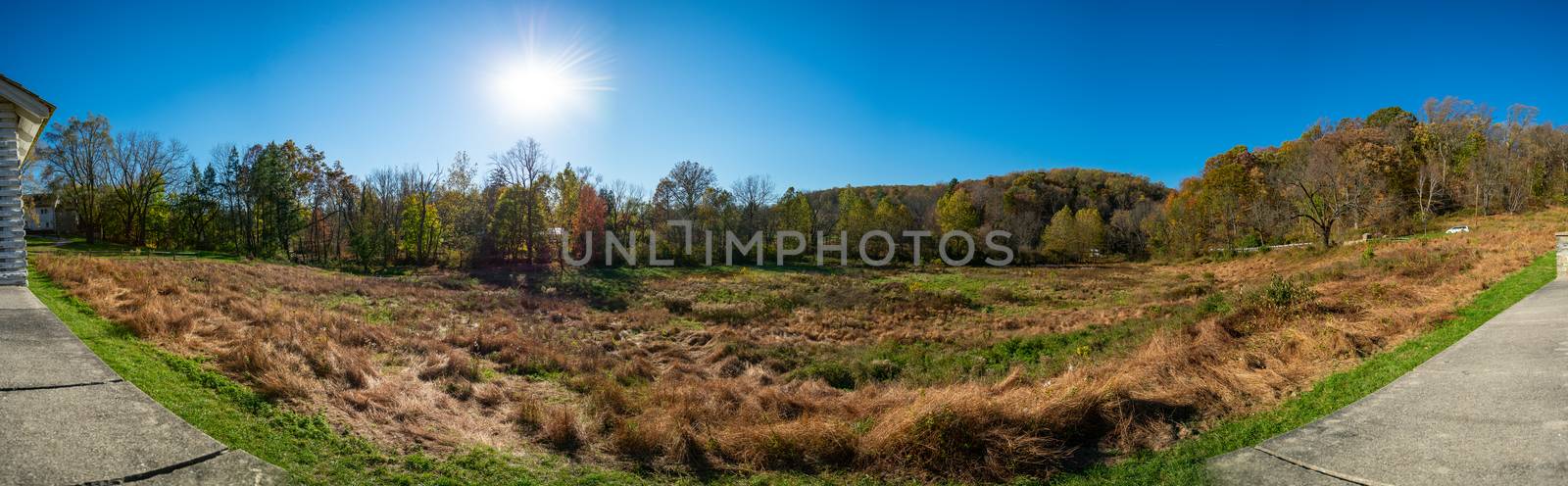 A Panoramic Shot of an Open Field on a Clear Autumn Day With the sun Behind Trees at Valley Forge