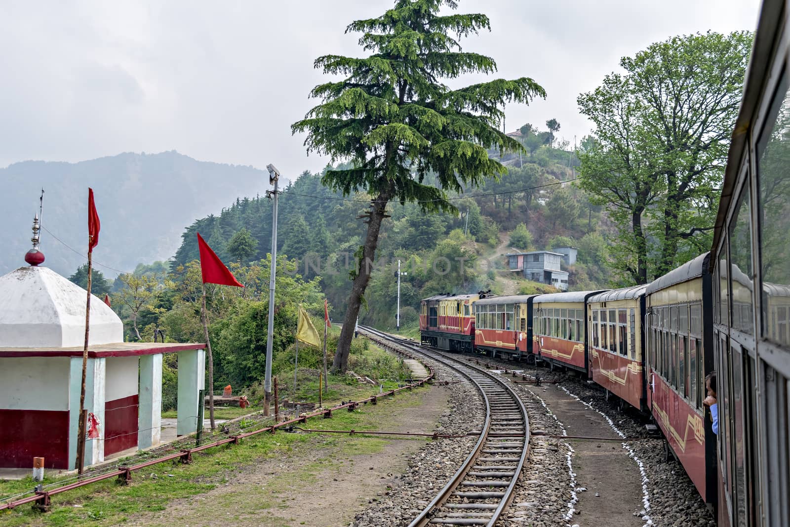 Shoghi,Himachal Pradesh, India: April 14th, 2015- Narrow gauge Shivalik Deluxe express train on curve while departing Shoghi.