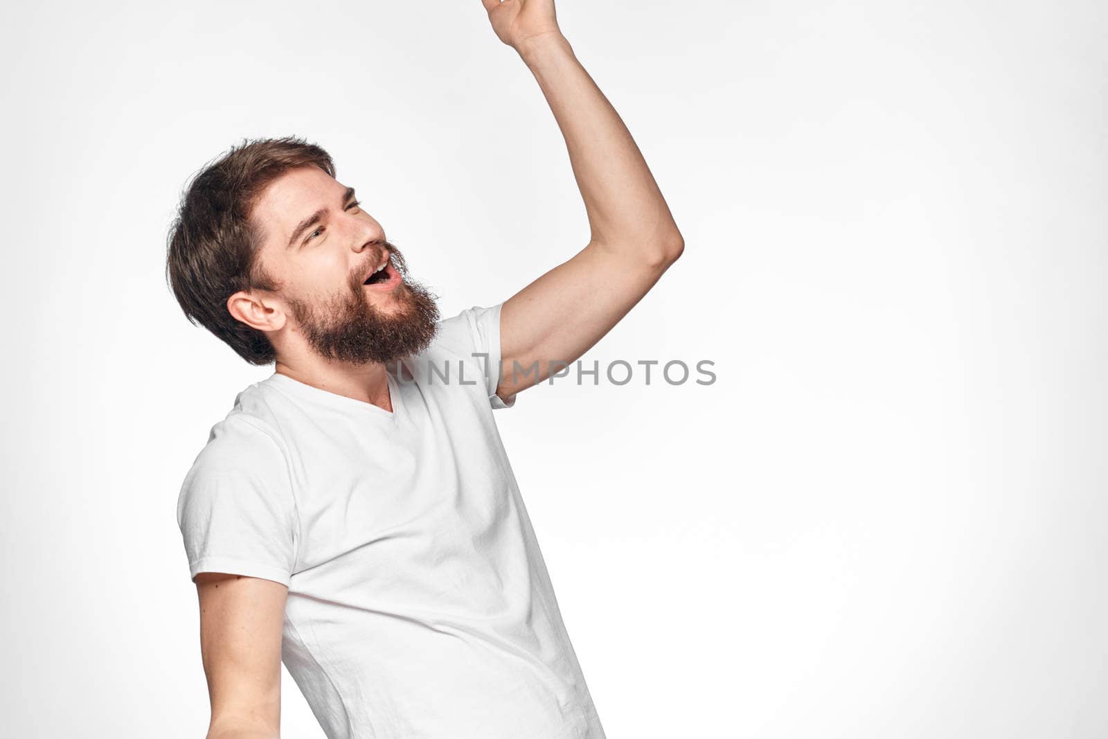 cheerful emotional bearded man gesturing with his hands close-up light background. High quality photo