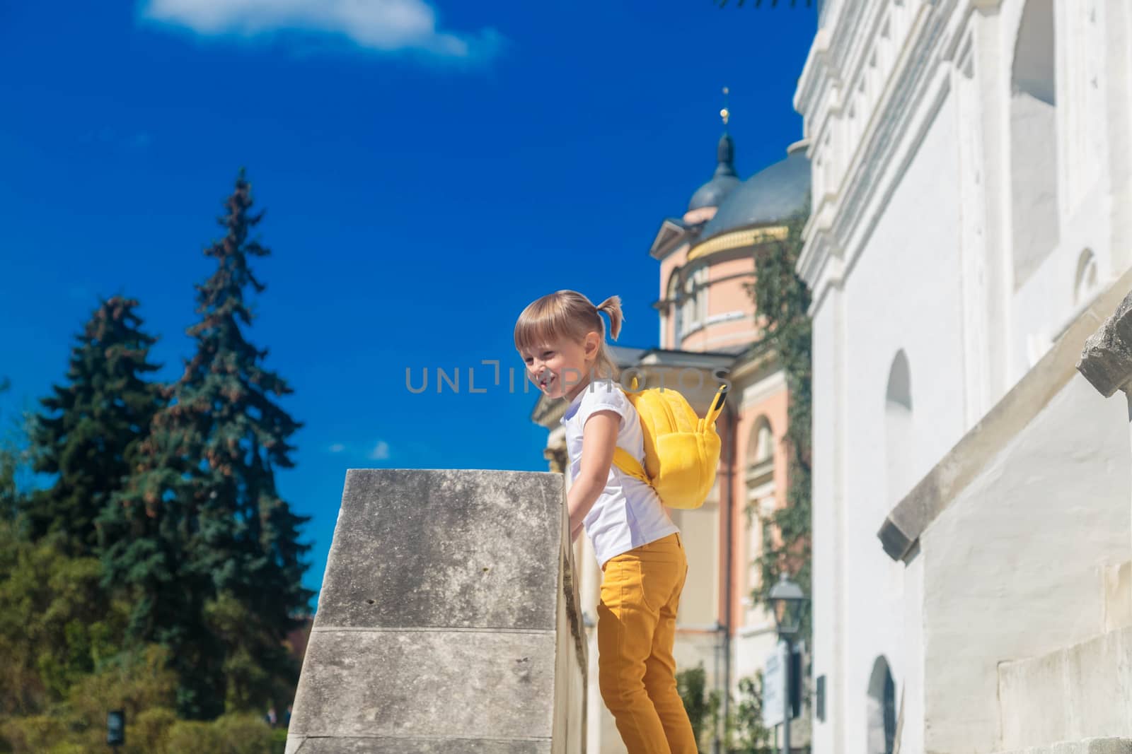 A little girl standing on the porch of a building by galinasharapova