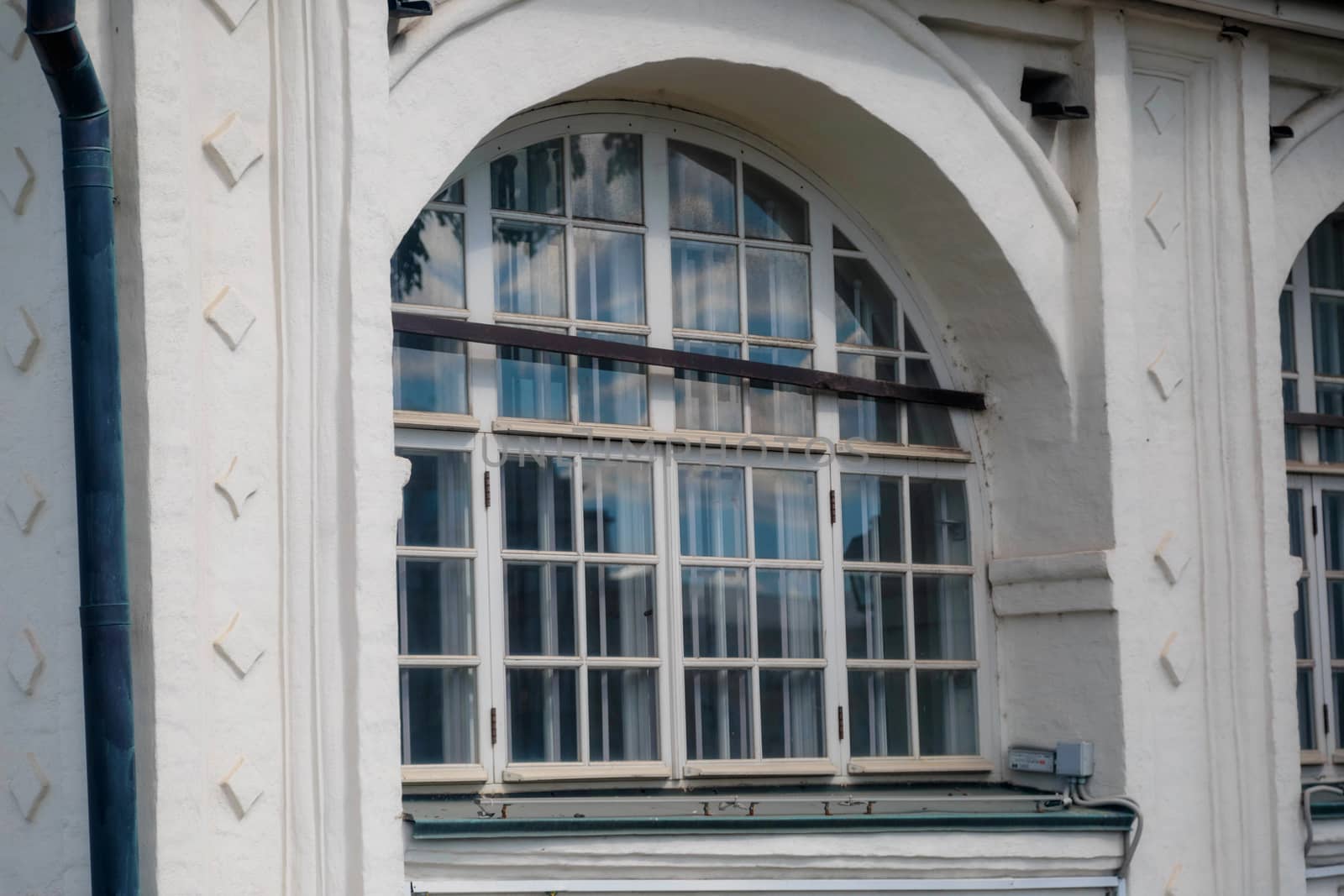 Part of the facade of a building and a large window of a Christian cathedral in Moscow