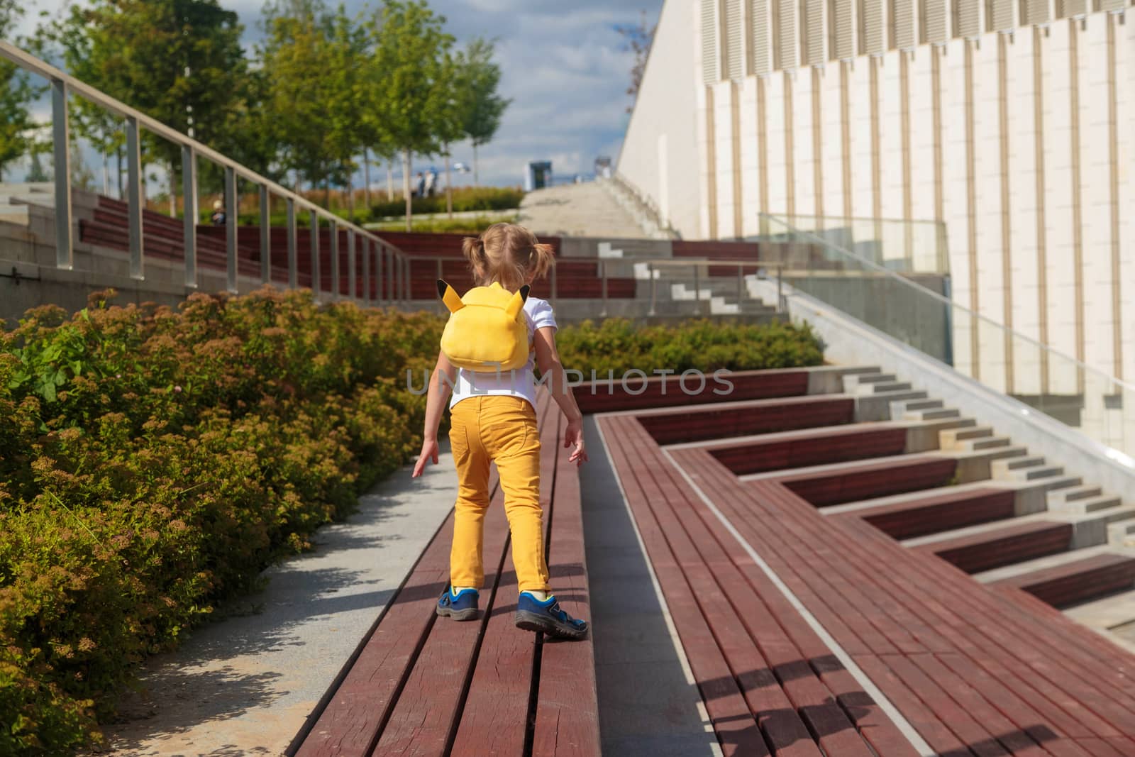 Little Girl in Yellow Jeans Runs Through the Park by galinasharapova