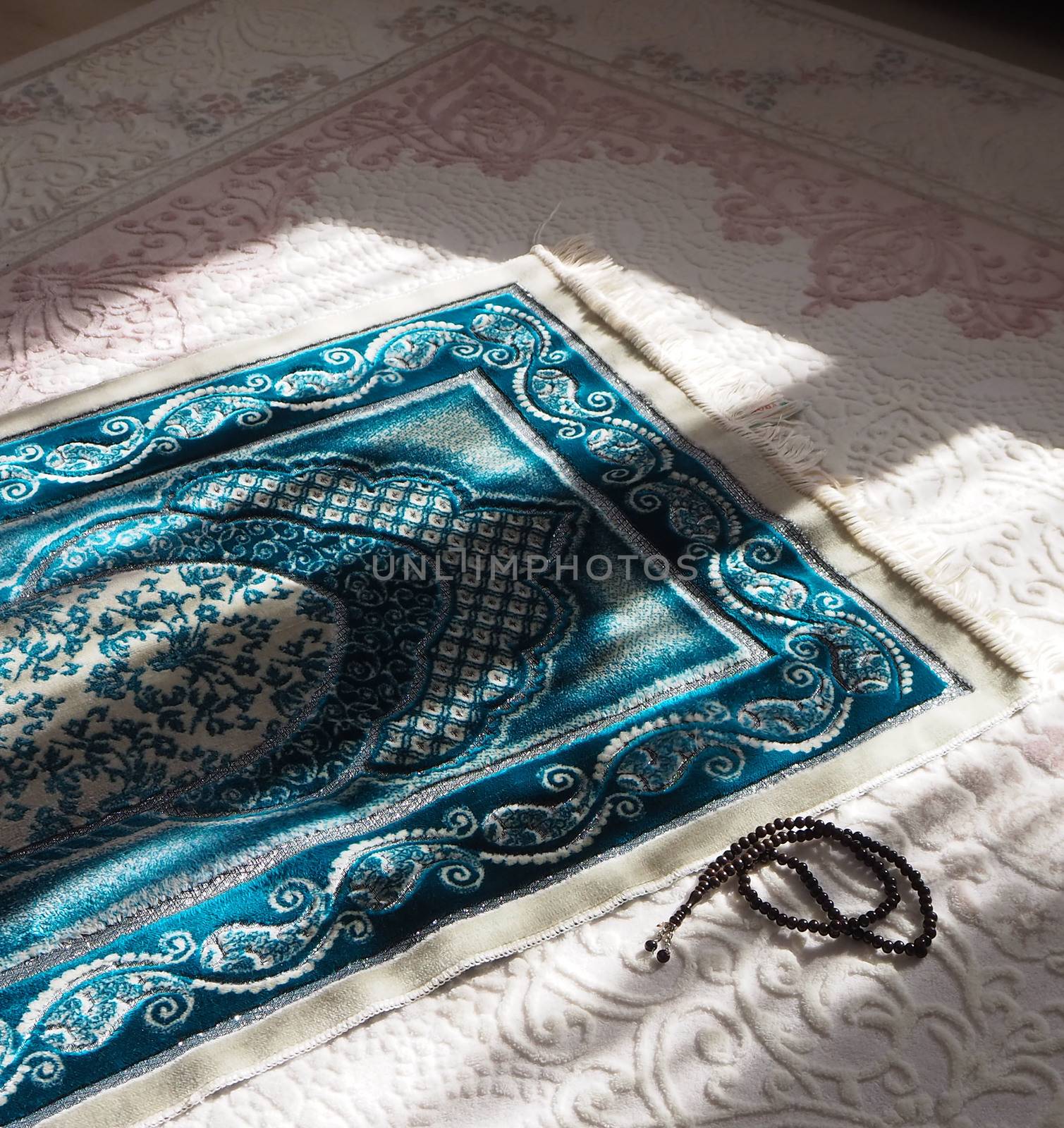 Prayer rug for praying in Islam, prayer rug and rosary laid under daylight, by nhatipoglu