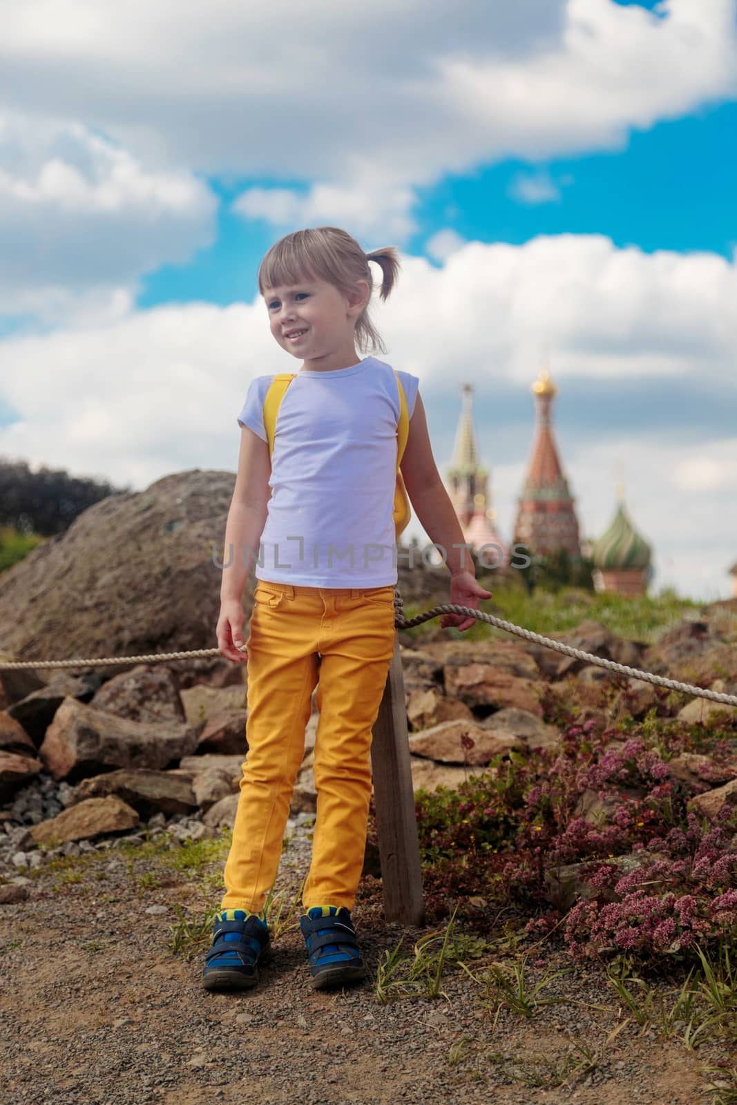 The girl looks to the side against the background of Zaryadye park.