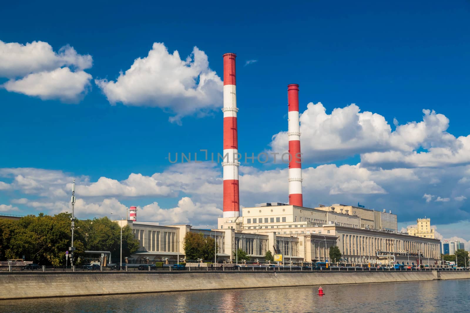 MOSCOW, RUSSIA - AUGUST 21, 2020:  Building with two pipes view from the moscow river to the embankment.