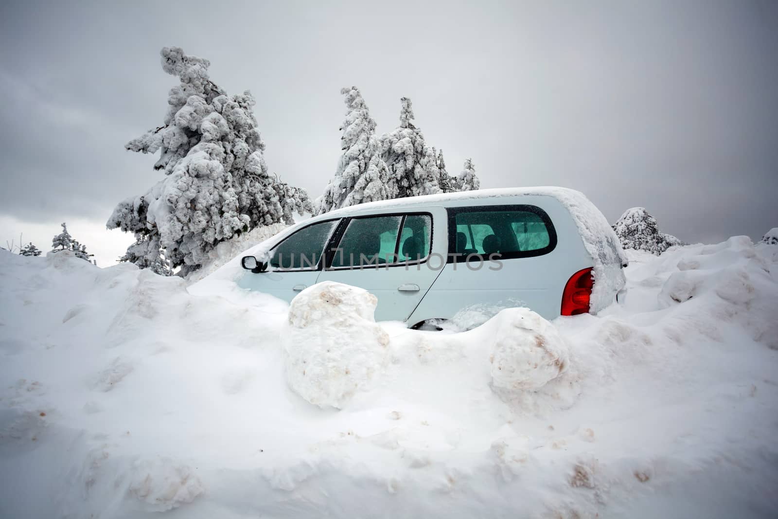 Car stuck in deep snow on mountain road - winter traffic problem stock image
