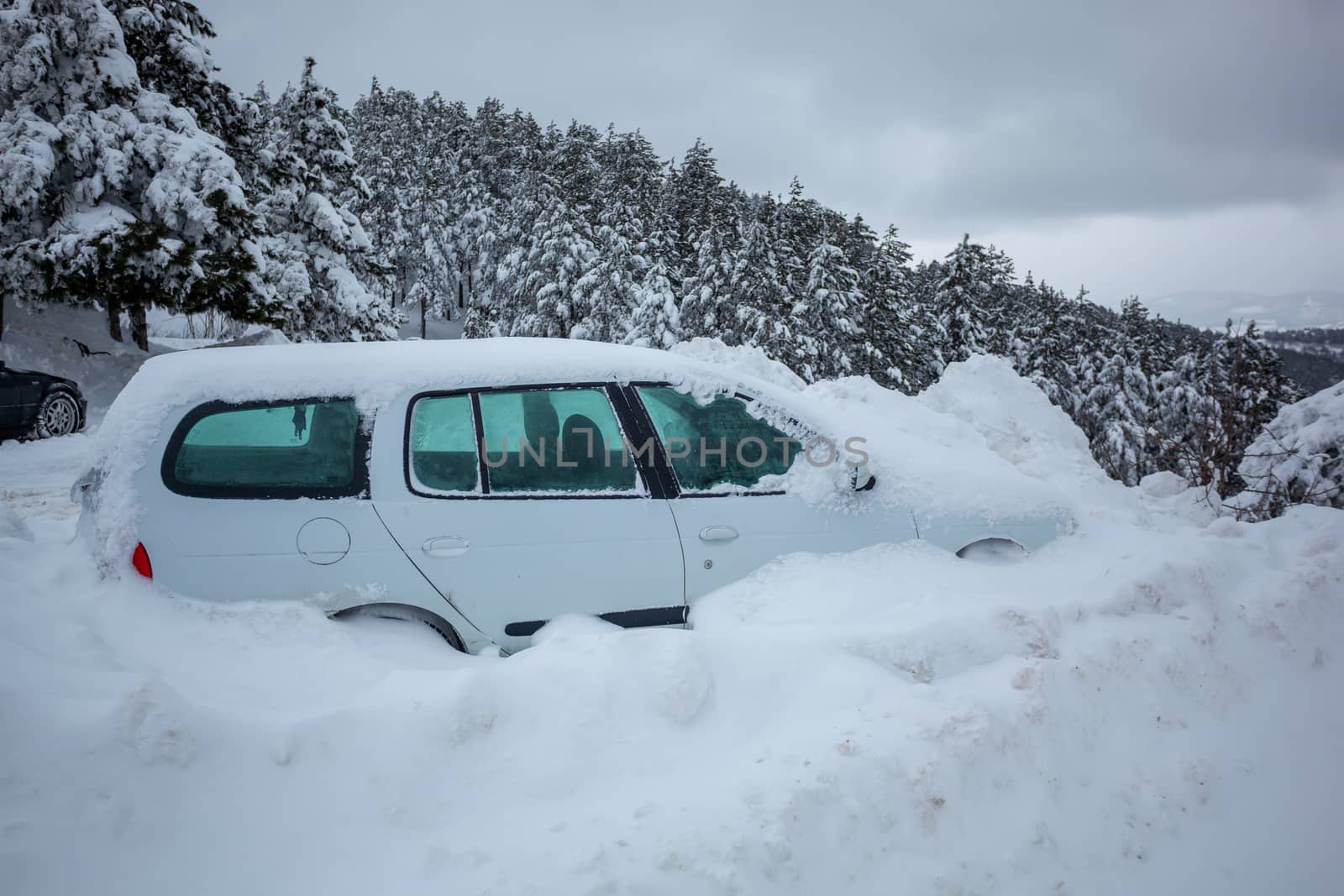 Car stuck in deep snow on mountain road - winter traffic problem stock image