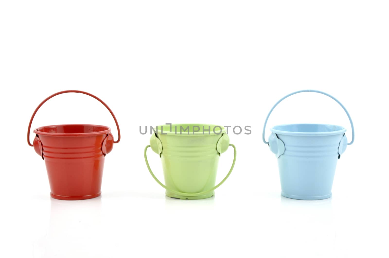 Three metal buckets of different colours with handle, isolated on white background